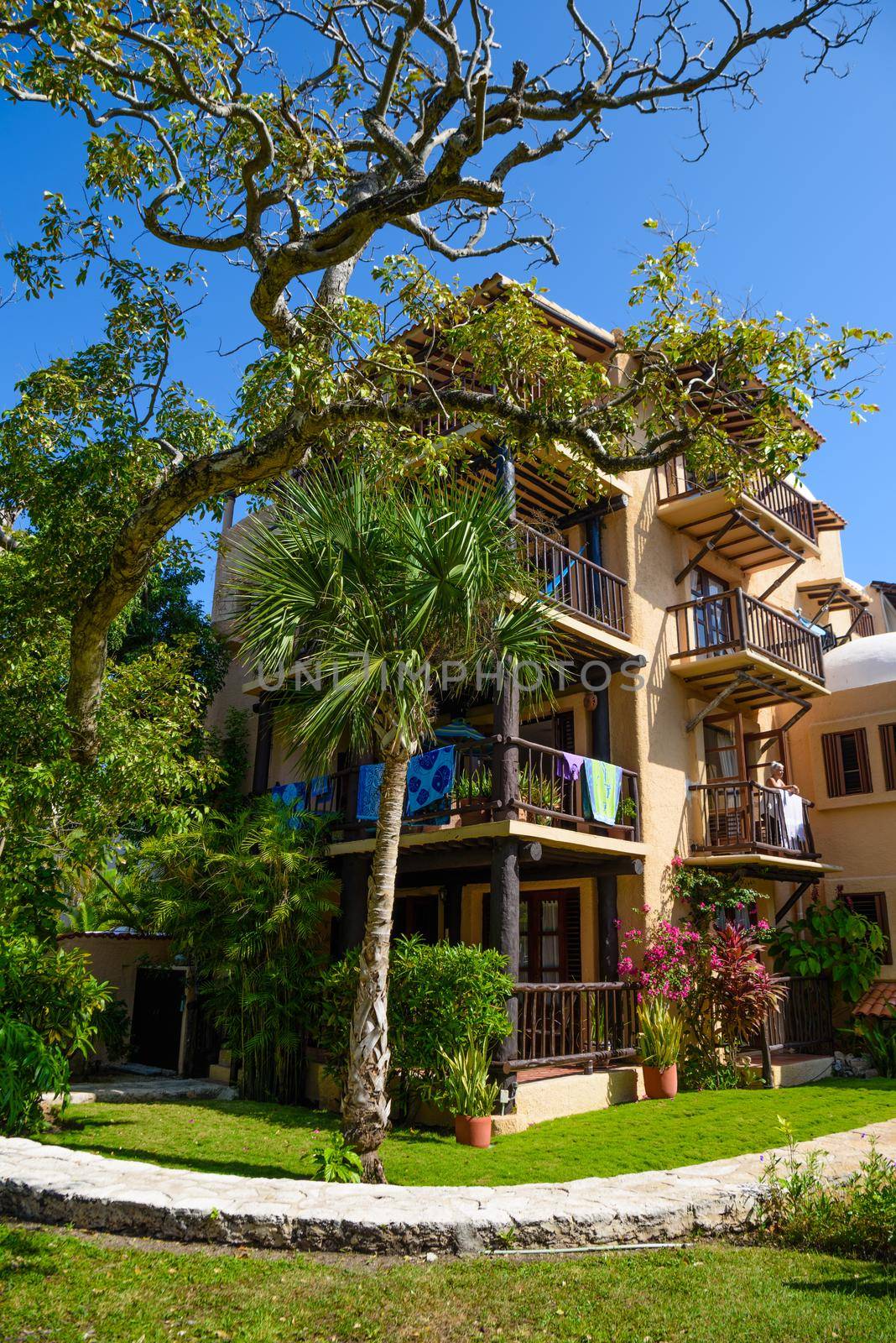 Beautiful yellow villa hotel among the trees in Playa del Carmen, Mexico.