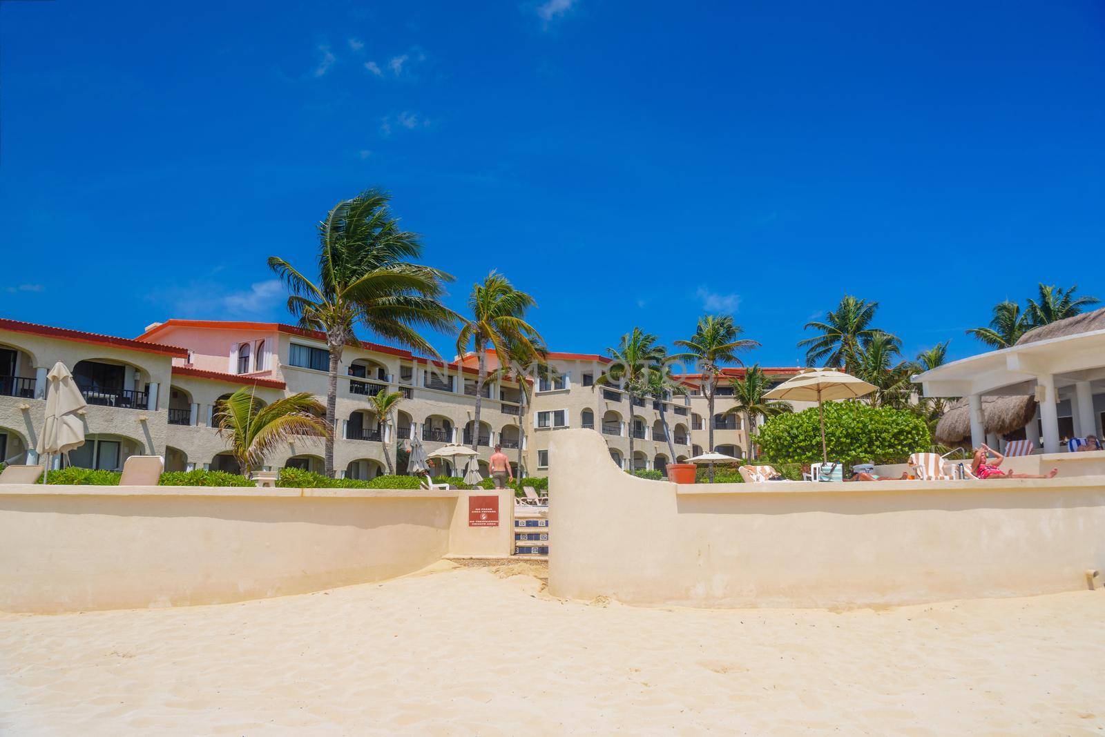 Hotel on a sandy beach on a sunny day in Playa del Carmen, Mexico by Eagle2308