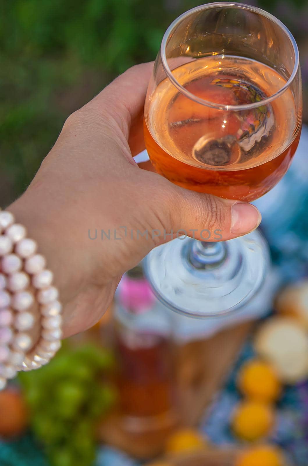 A woman and a man drink wine in a lavender field. Selective focus. Food.