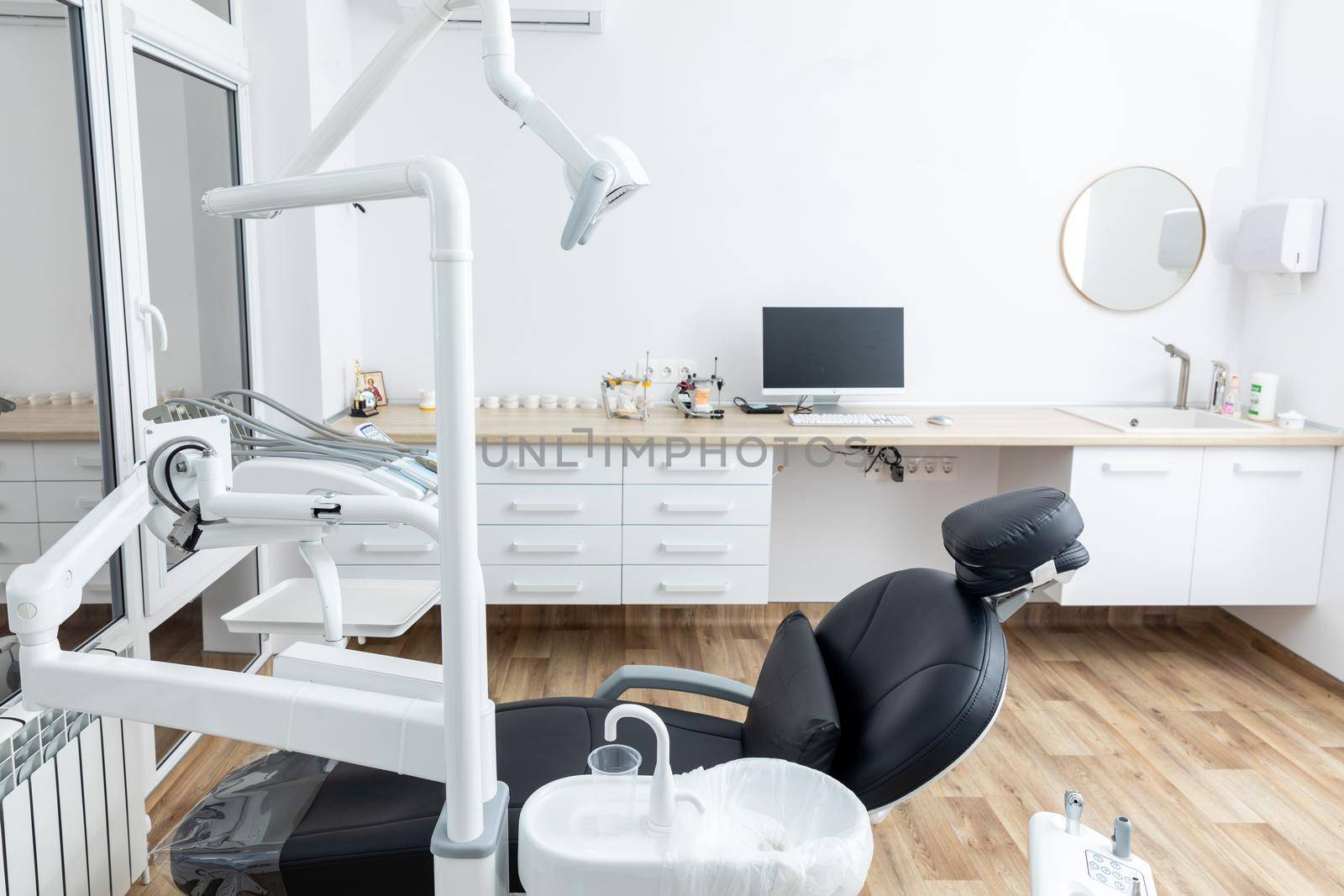 Modern dental cabinet in white colors. Defferent dental equipment, chair, lamp, drill machines. Concept dental treatment with microscope