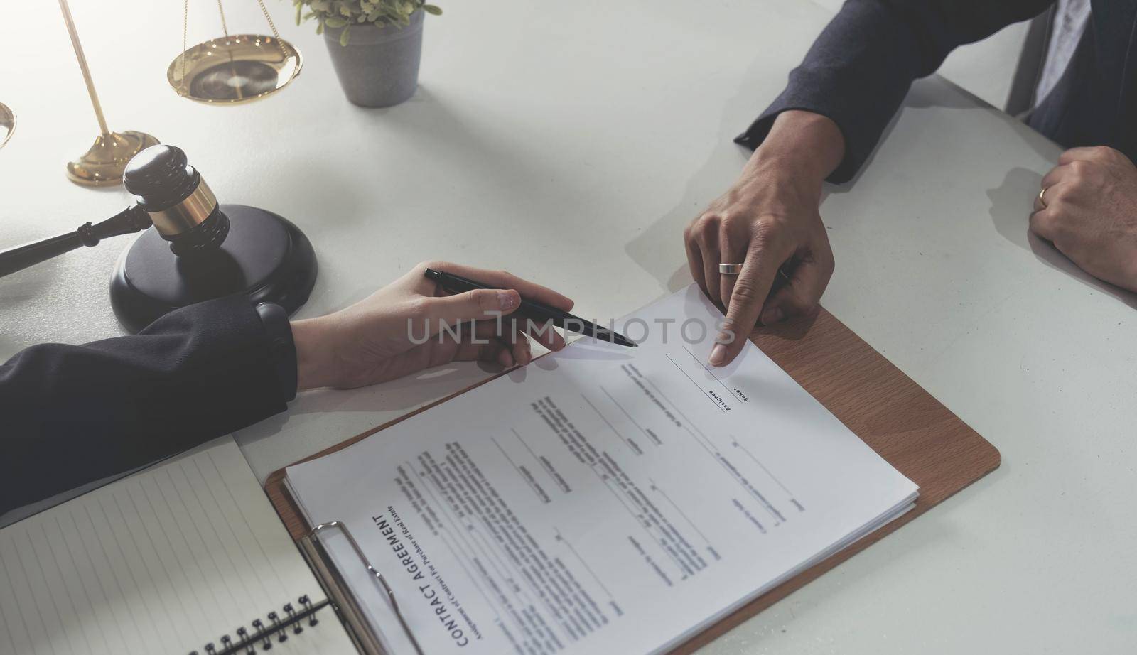 business people working together at meeting in modern office, close-up. Businessman and woman with colleagues or lawyers discussing contract at negotiation.