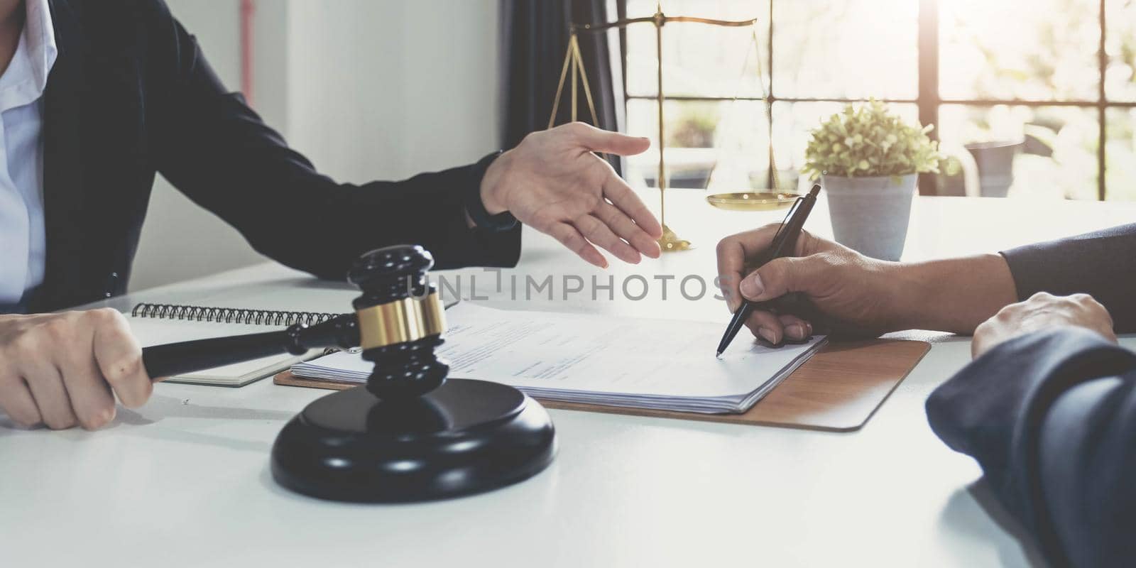 Business woman and lawyers discussing contract papers with brass scale on wooden desk in office. Law, legal services, advice, Justice concept..