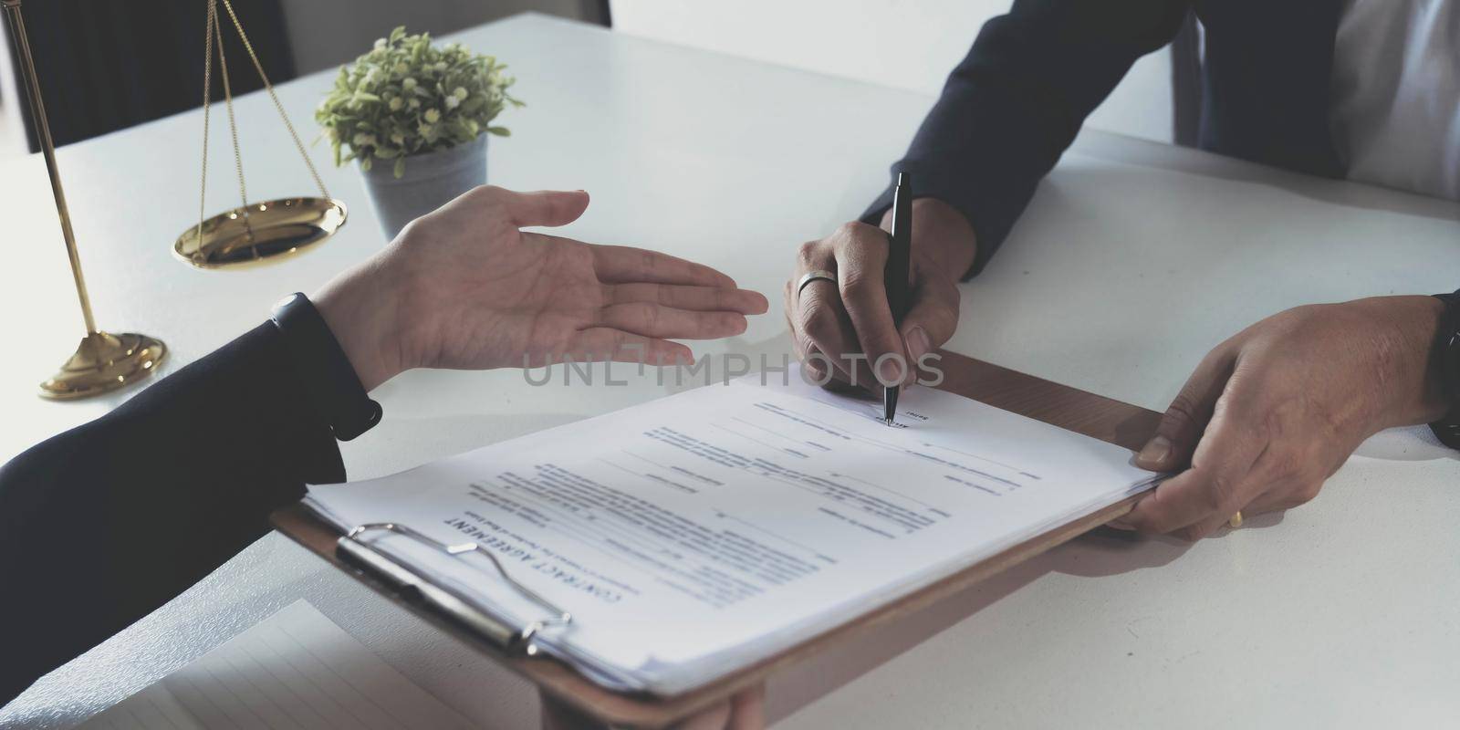 business people and lawyers discussing contract papers sitting at the table. Concepts of law, advice, legal services. by wichayada