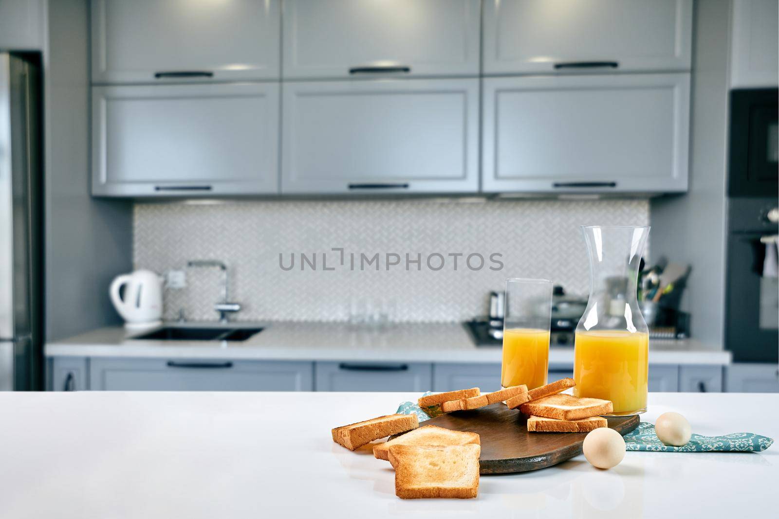 Continental breakfast - orange juice and toast on white table. by nazarovsergey