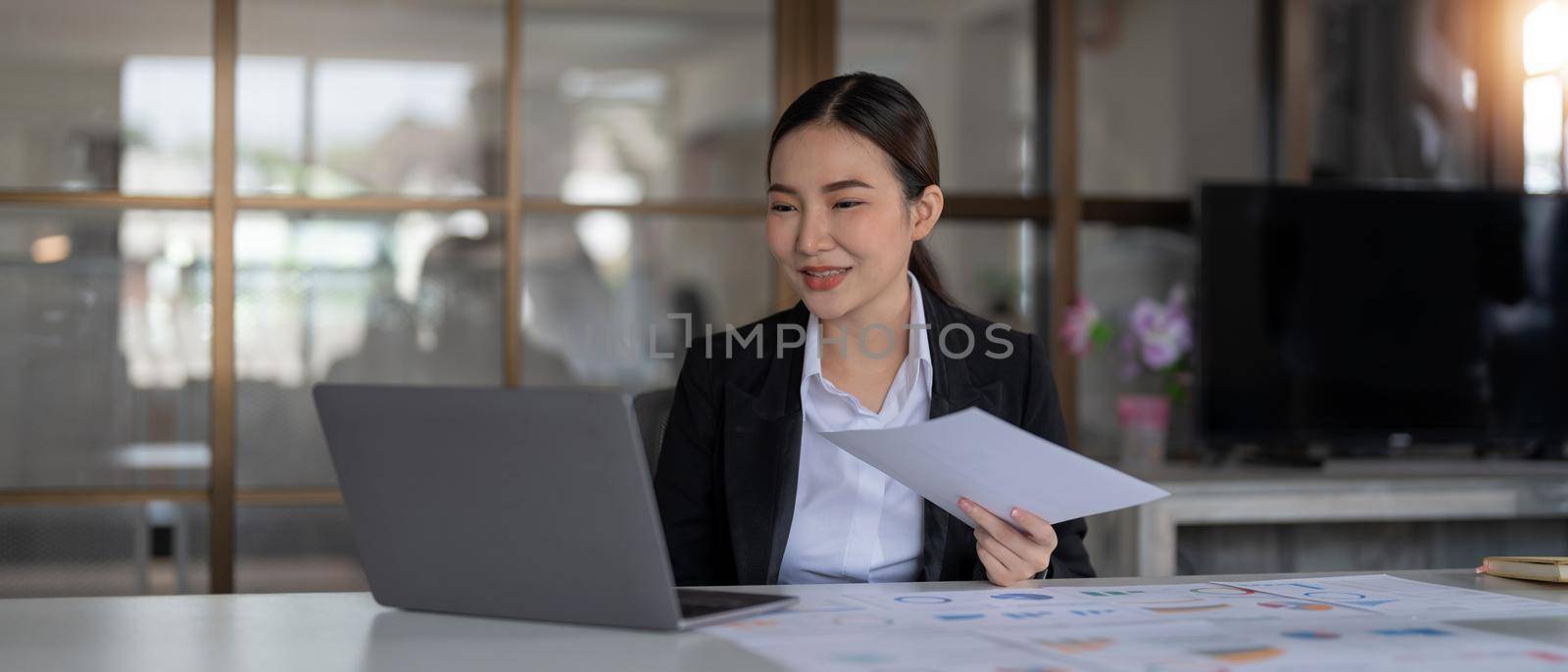 Portrait business woman accountant working audit and calculating expense financial annual financial report balance sheet statement, doing finance making notes on paper checking document