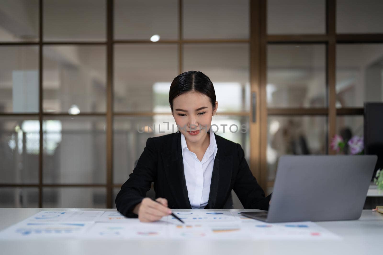 Portrait of smiling beautiful business asian woman with working in modern office desk using computer, Business people employee freelance online marketing e-commerce telemarketing concept.