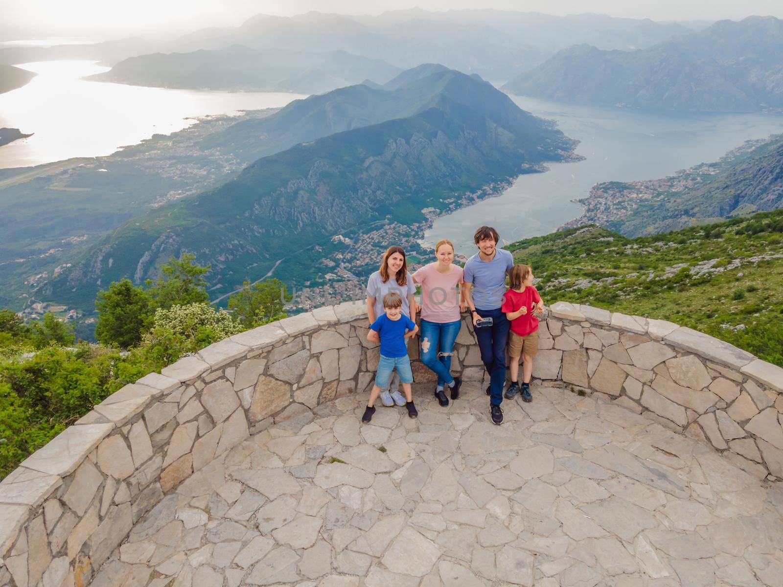 happy friends enjoys the view of Kotor. Montenegro. Bay of Kotor, Gulf of Kotor, Boka Kotorska and walled old city. Travel to Montenegro concept. Fortifications of Kotor is on UNESCO World Heritage by galitskaya