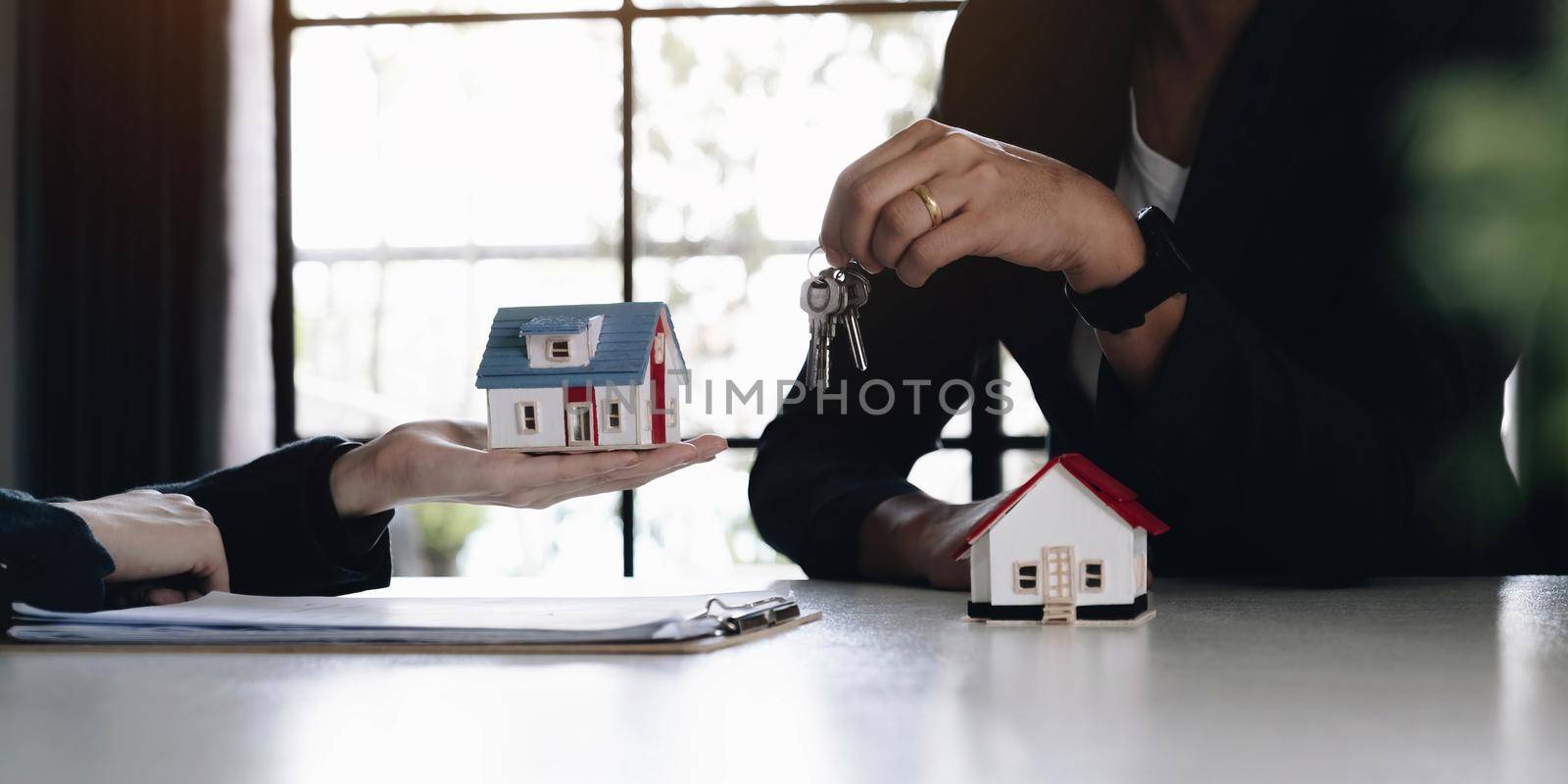 Home and real estate trading business. Real estate agent giving keys to house woman owner..