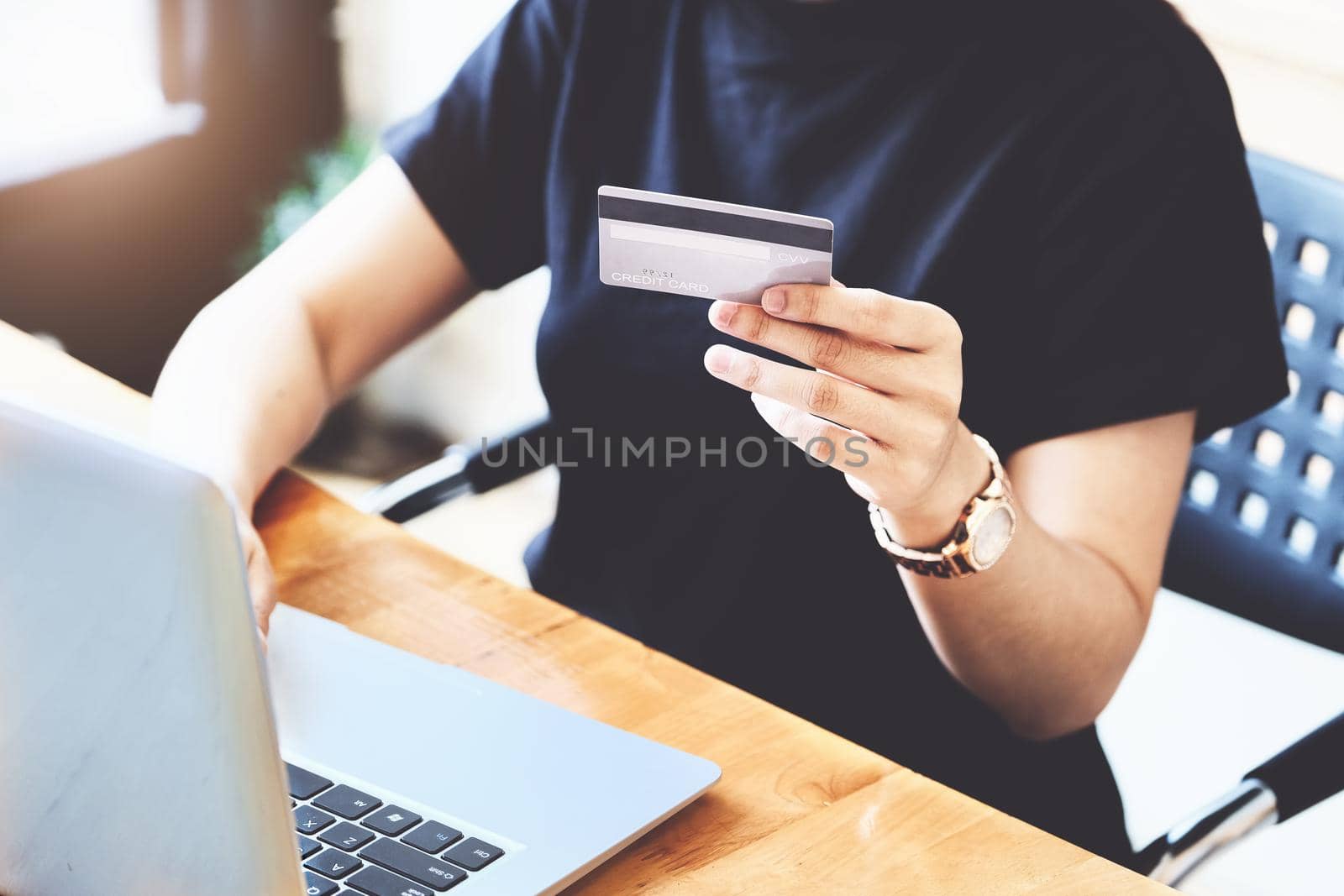 Online payment with Young Women hands holding credit card and using computer for online shopping by Manastrong