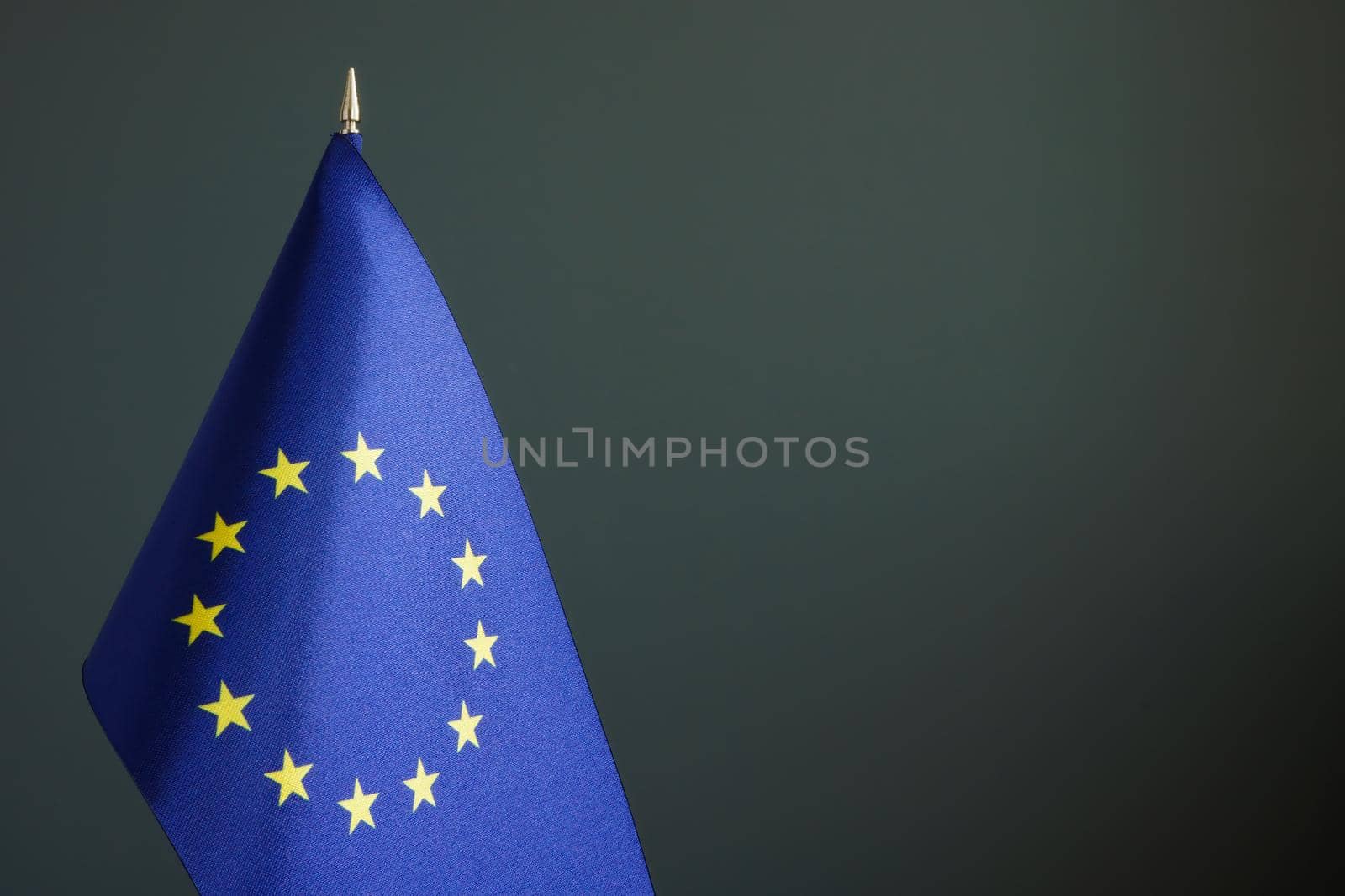 A Small EU flag and dark empty space.