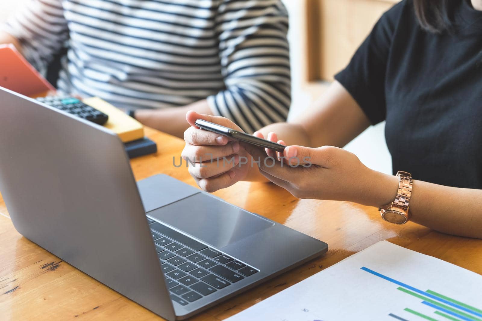 Focus on female employees using the phone while talking to male employees about workplace budgets