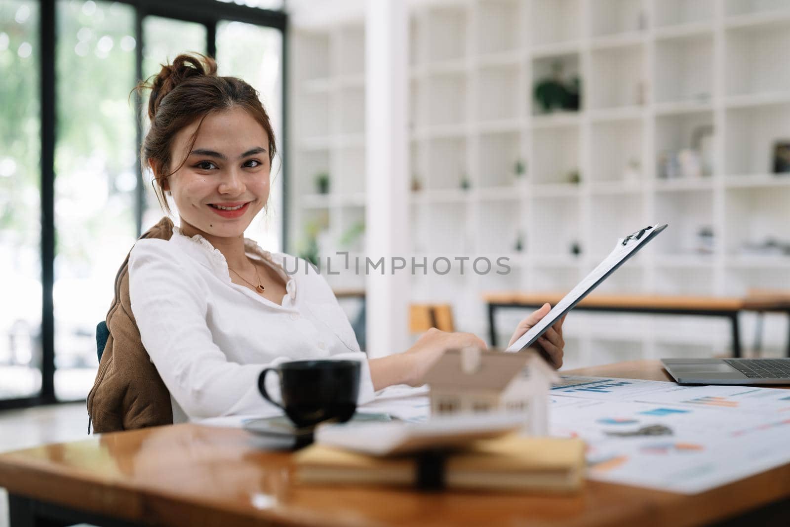 Portrait of smiling beautiful business asian woman with working in modern office desk using computer, Business people employee freelance online marketing e-commerce telemarketing concept