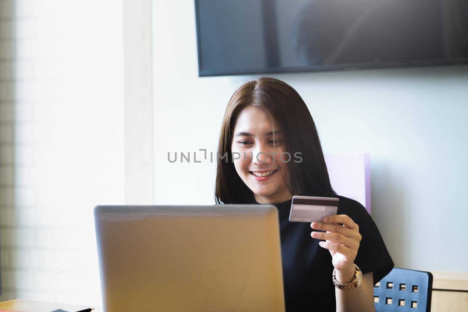Online payment with Young Women hands holding credit card and using computer for online shopping