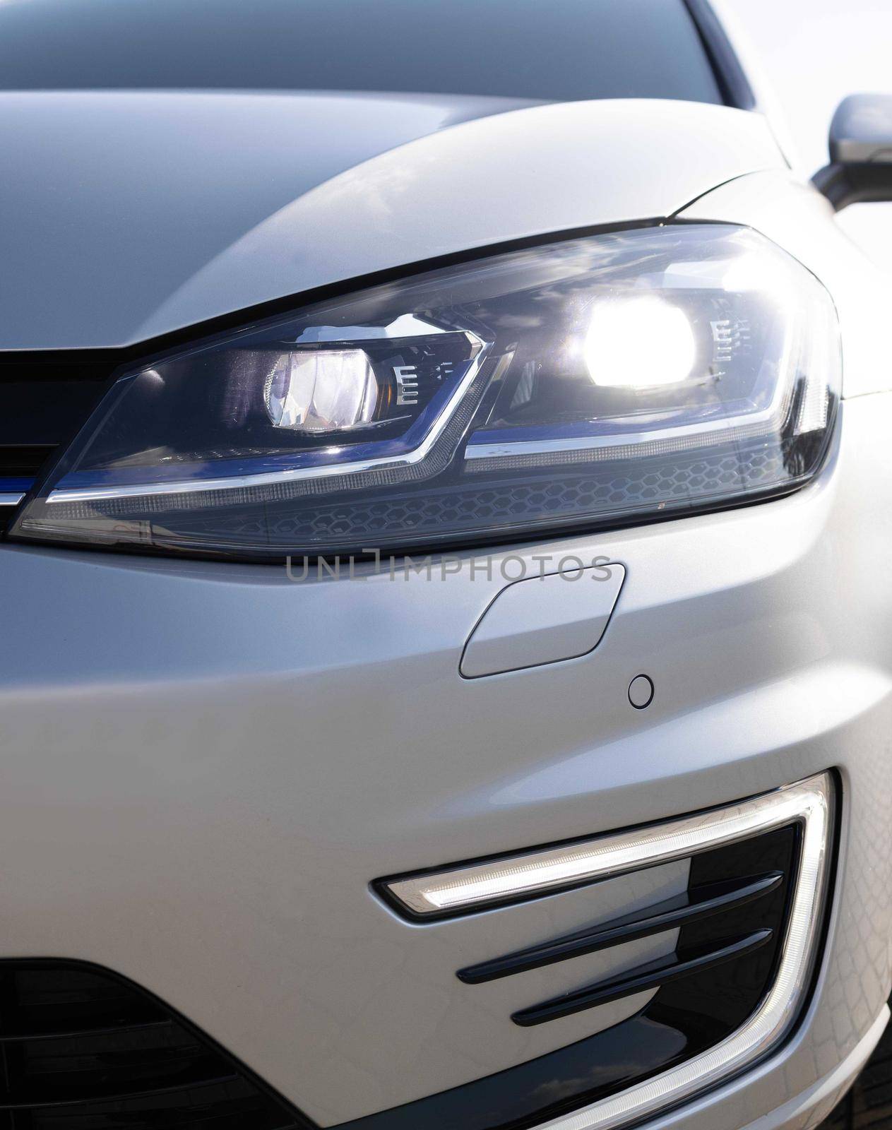 Modern car headlamp flashing light with blinking on continuously indicator. Car Front Full Led Light. Switched on led lights of luxury car. Car Blinker Light.
