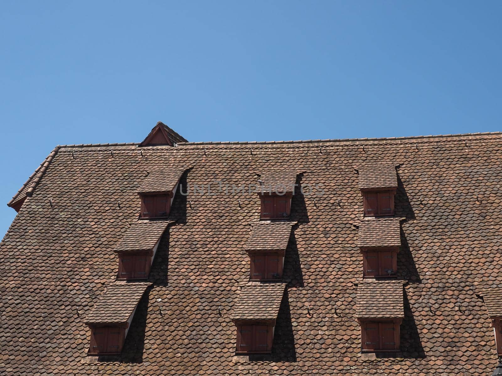 ancient dormer windows in a high roof
