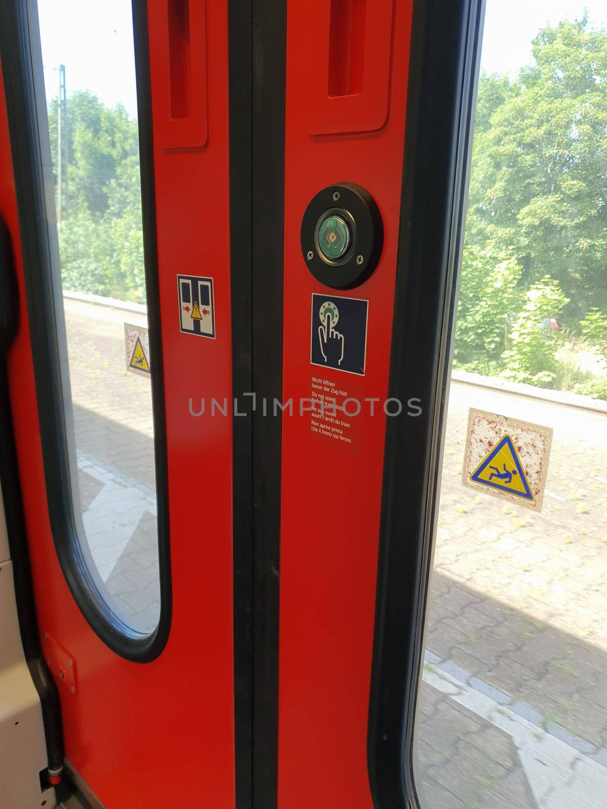Do not open before train stops on train door written in German English French and Italian