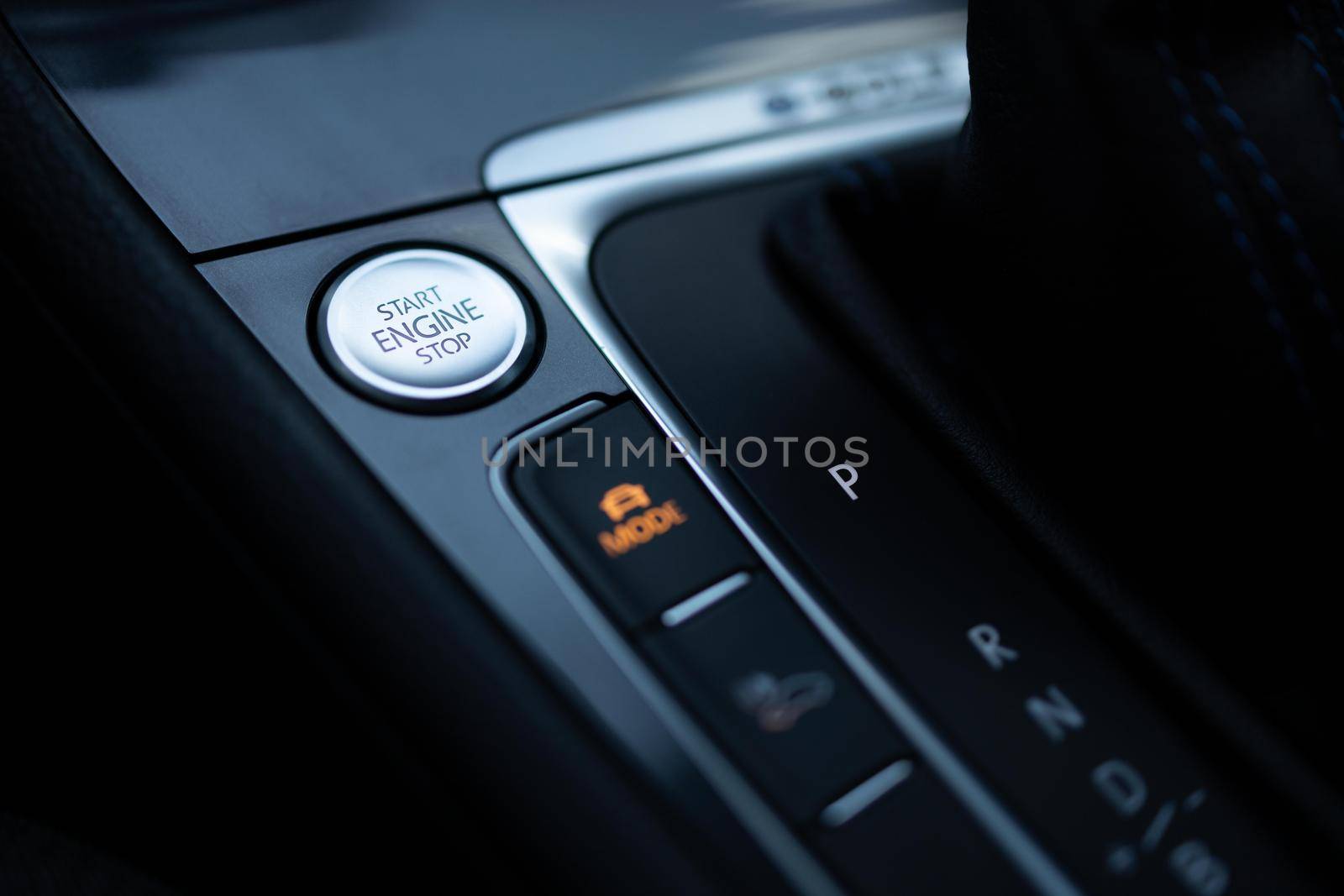 Start-stop buttons on modern cars selective focus. Silver start and stop button. Automatic electric car.