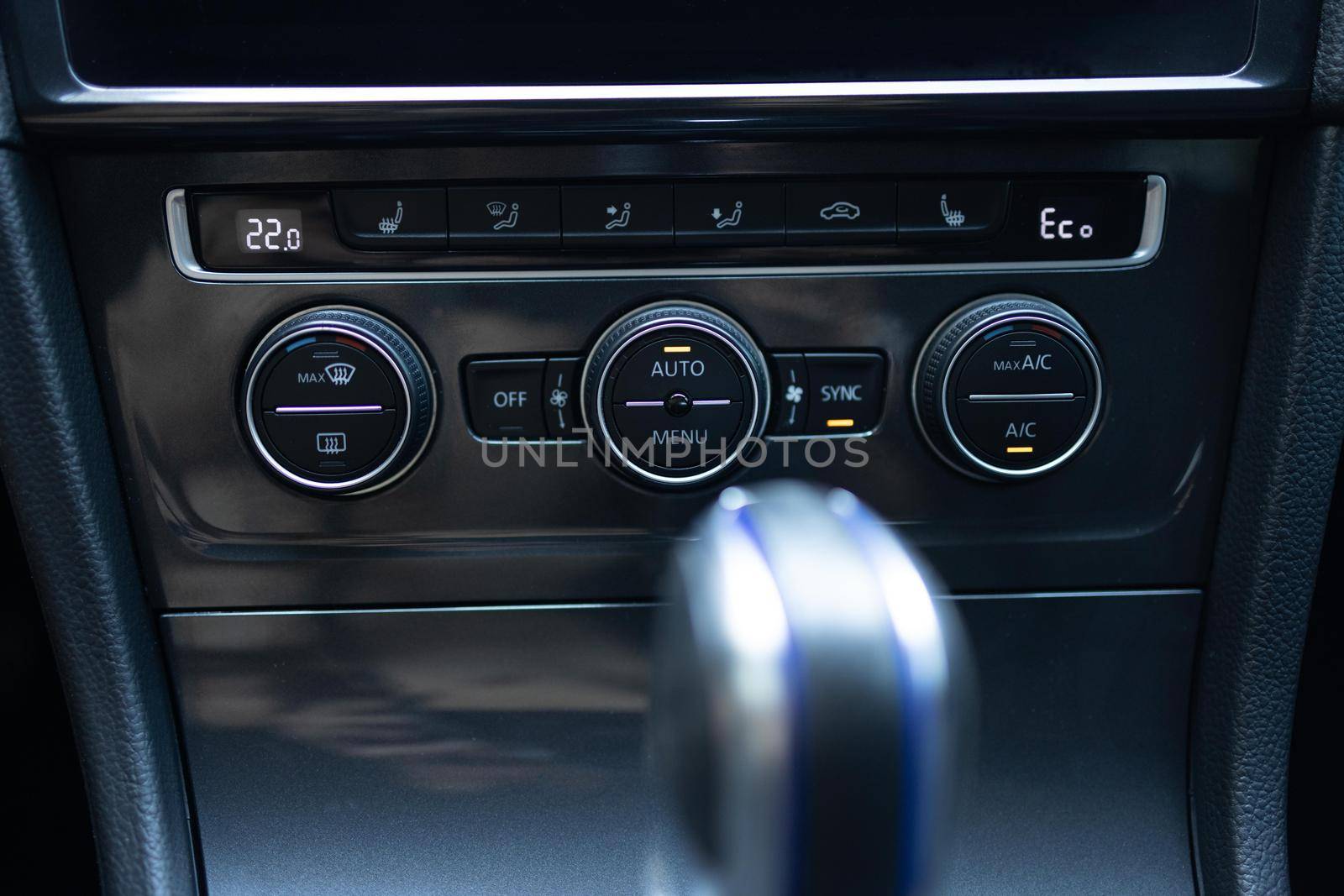 Modern car climate control panel for driver and passenger with shallow depth of field. Zone climate control. Car interior detail. Car air conditioning button inside a car.