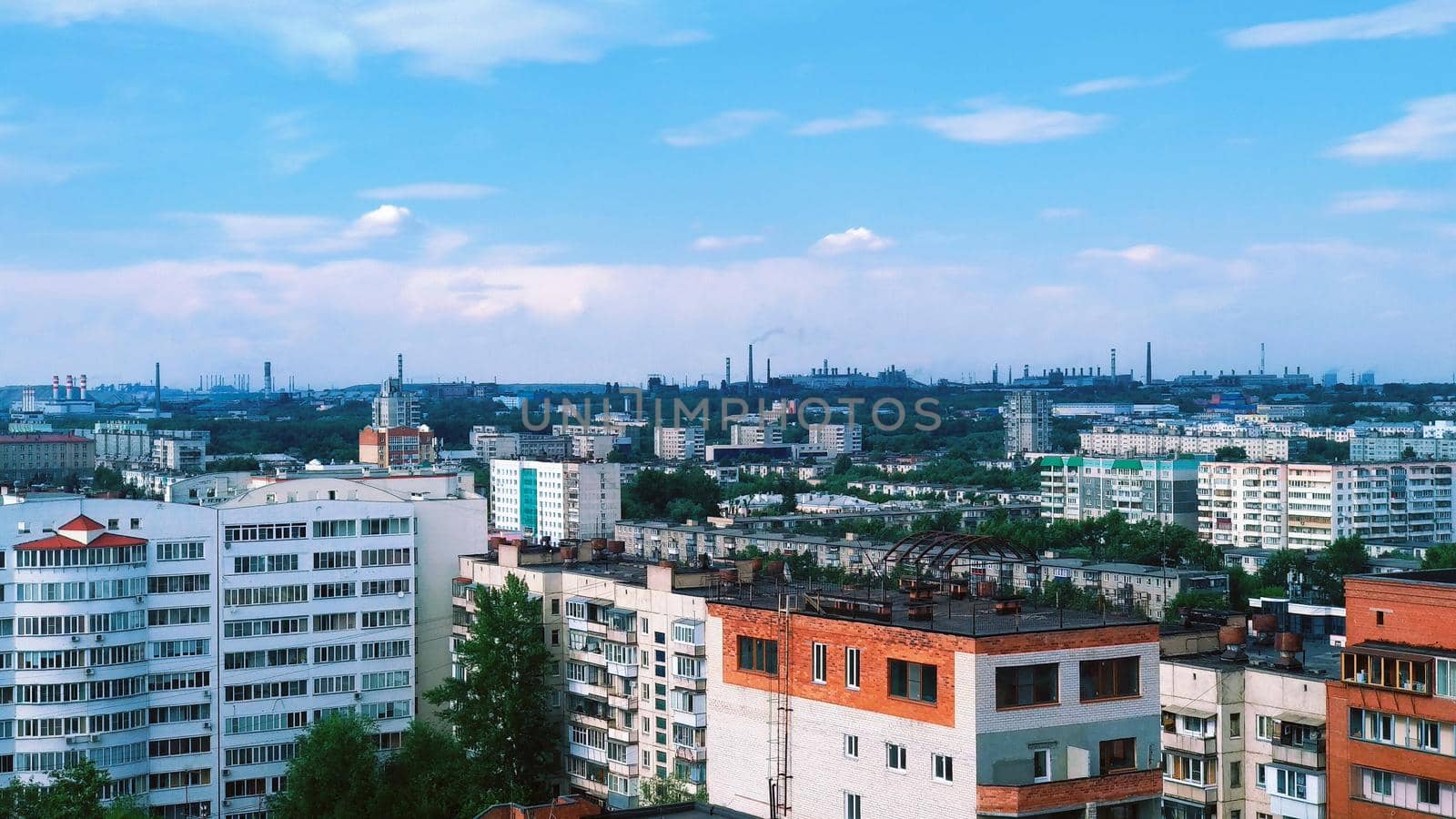 Panorama of an industrial city with many buildings and chimney factories on the horizon by ProjectStockman