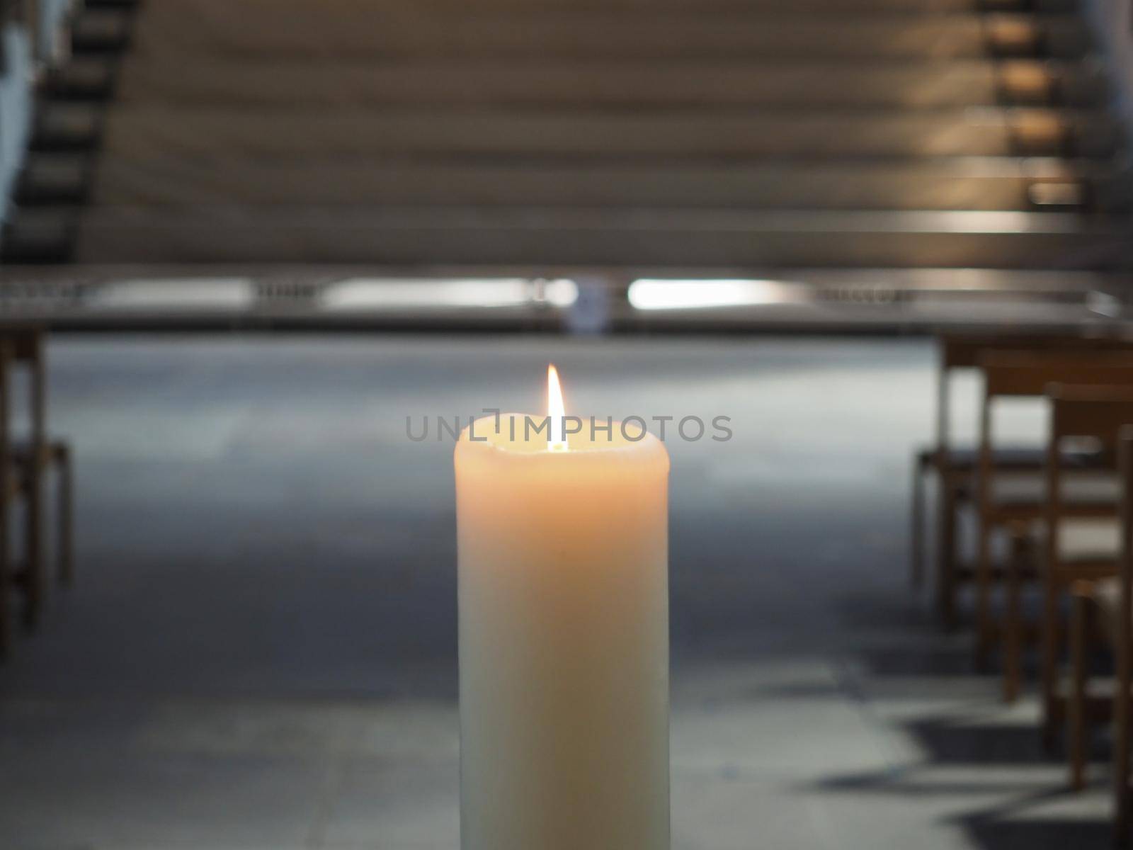 candle symbol of faith burning in a Christian church