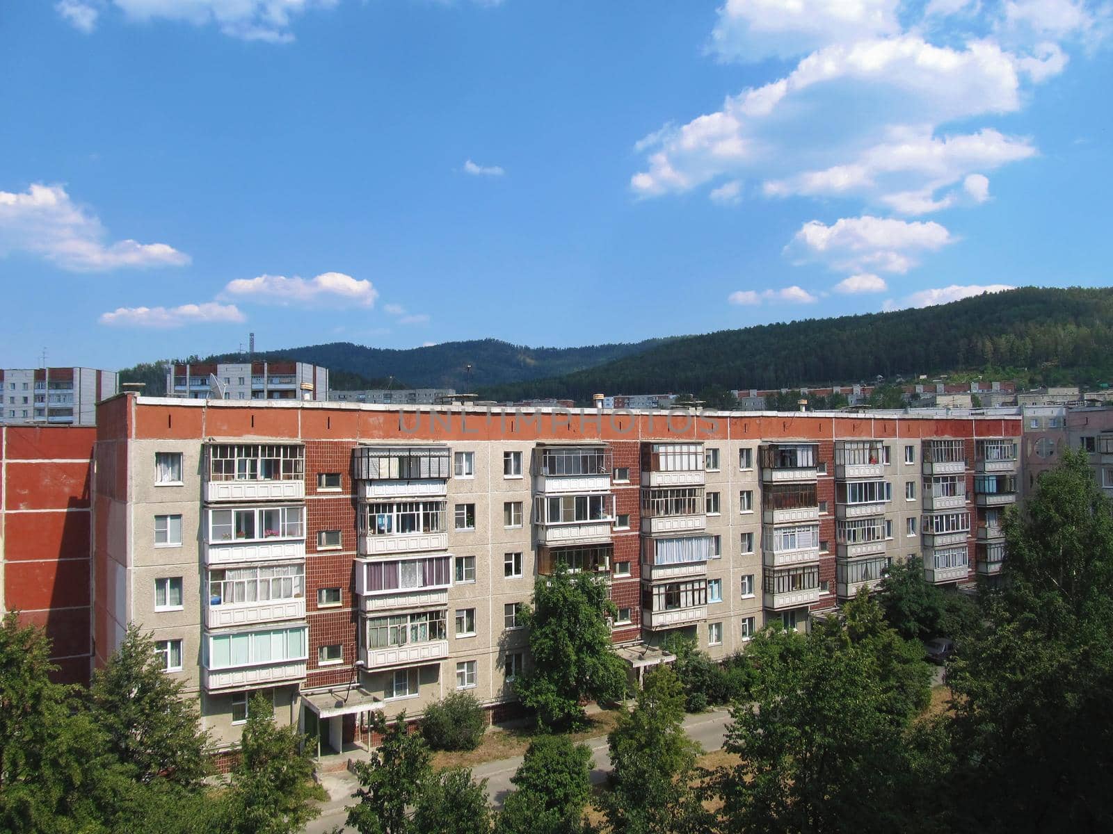 Multi-storey residential building among low mountains