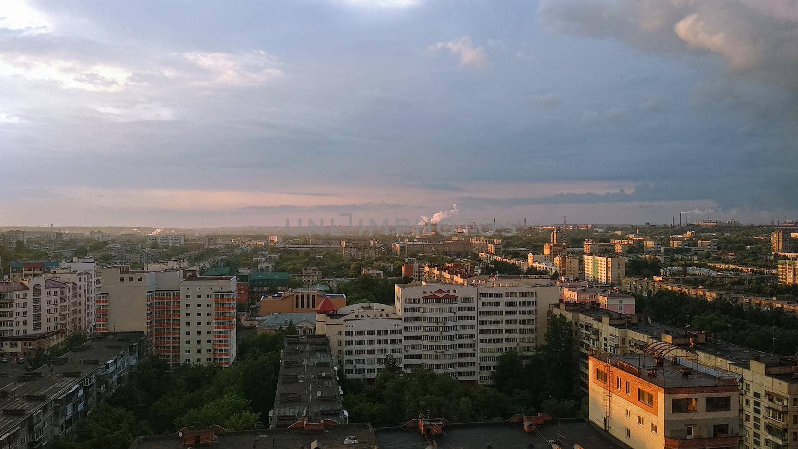 Panorama of an industrial big city under the rays of the evening sun by ProjectStockman