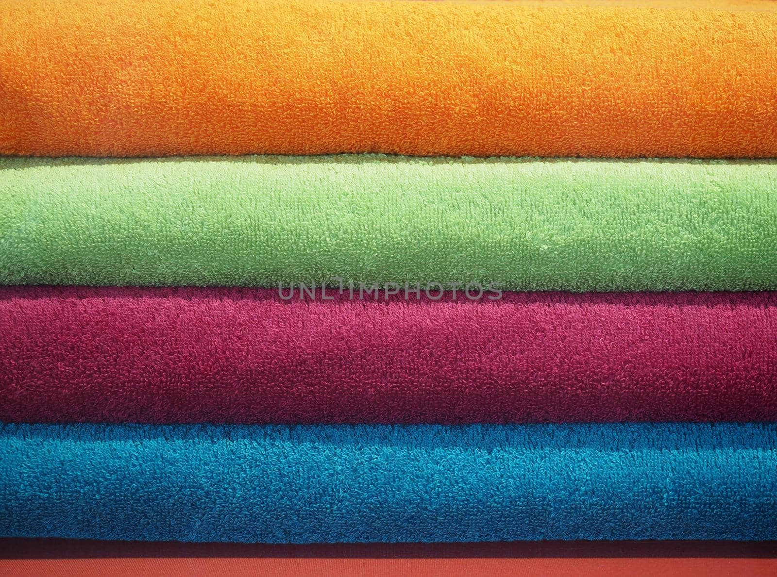 multicolored cotton towels including orange green red and blue useful as a background