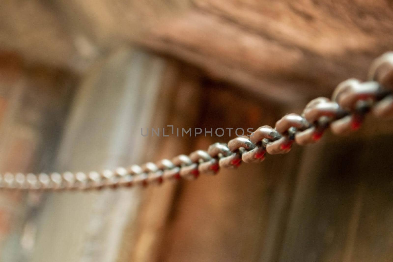 Old Chains. Old metal chain on water background in the sunlight. High quality photo