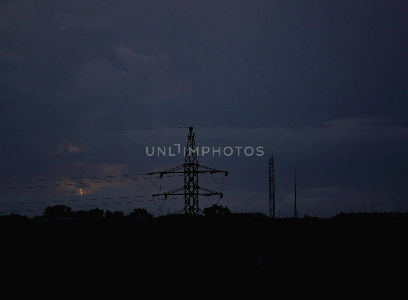 Power lines against the background of a stormy sky and lightning by ProjectStockman