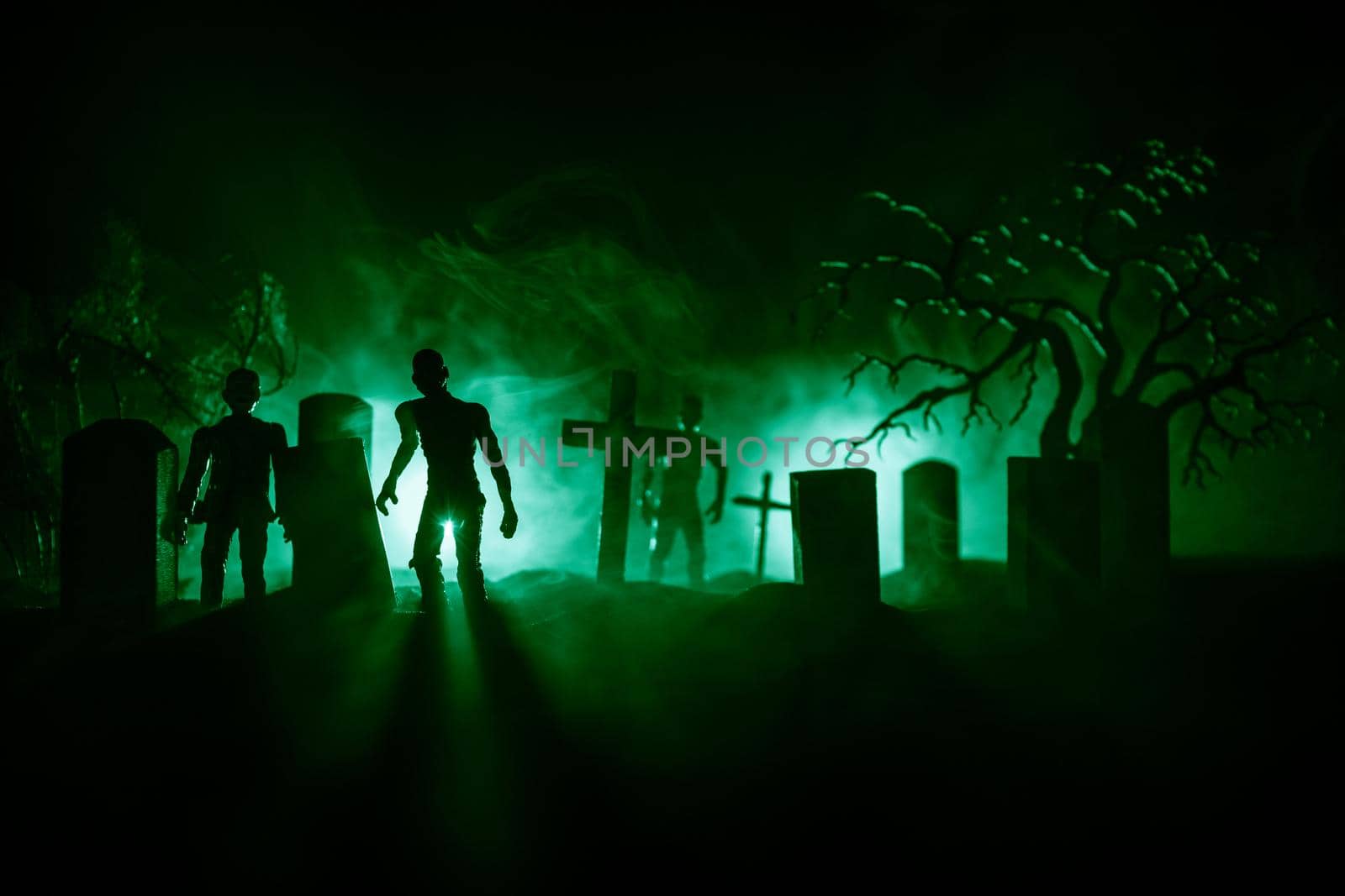 Scary view of zombies at cemetery dead tree, moon, church and spooky cloudy sky with fog, Horror Halloween concept with glowing pumpkin. Selective focus by Zeferli