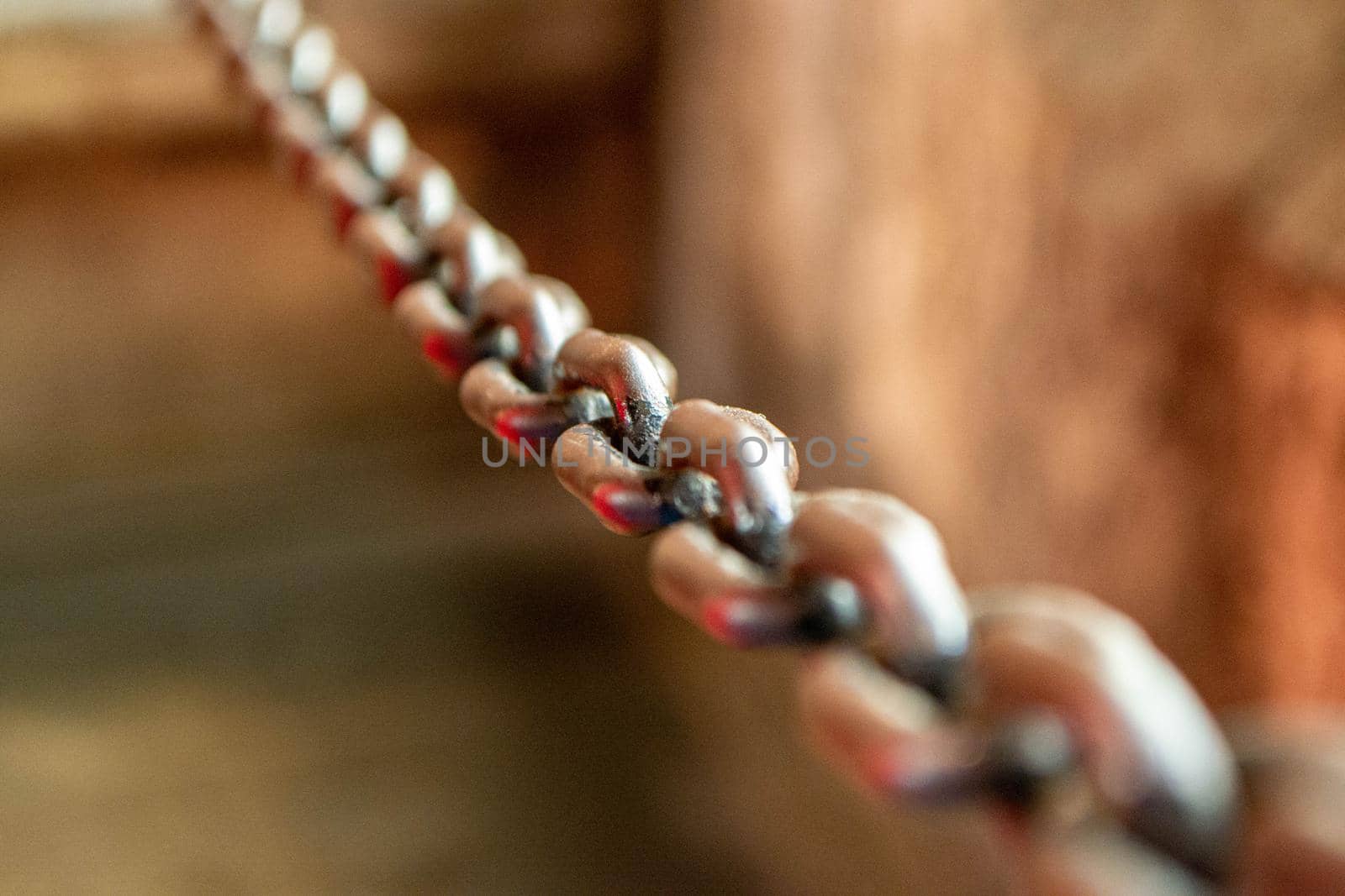 Old Chains. Old metal chain on water background in the sunlight. High quality photo