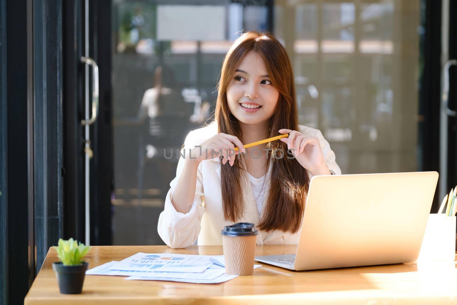 Happy businesswoman relaxing at office desk.