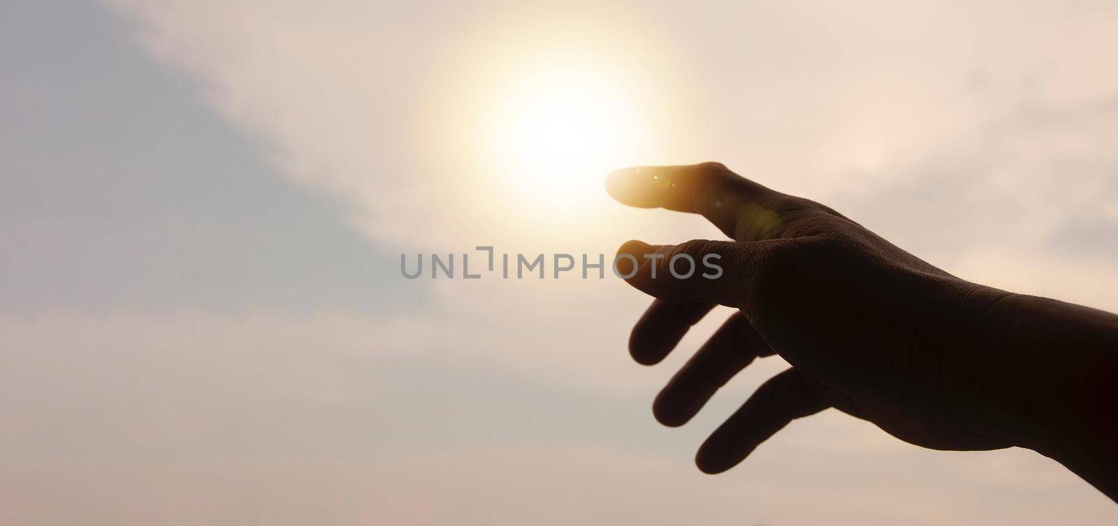 Hands reaching out to bright sky with copy space for ideas or text. Copy space