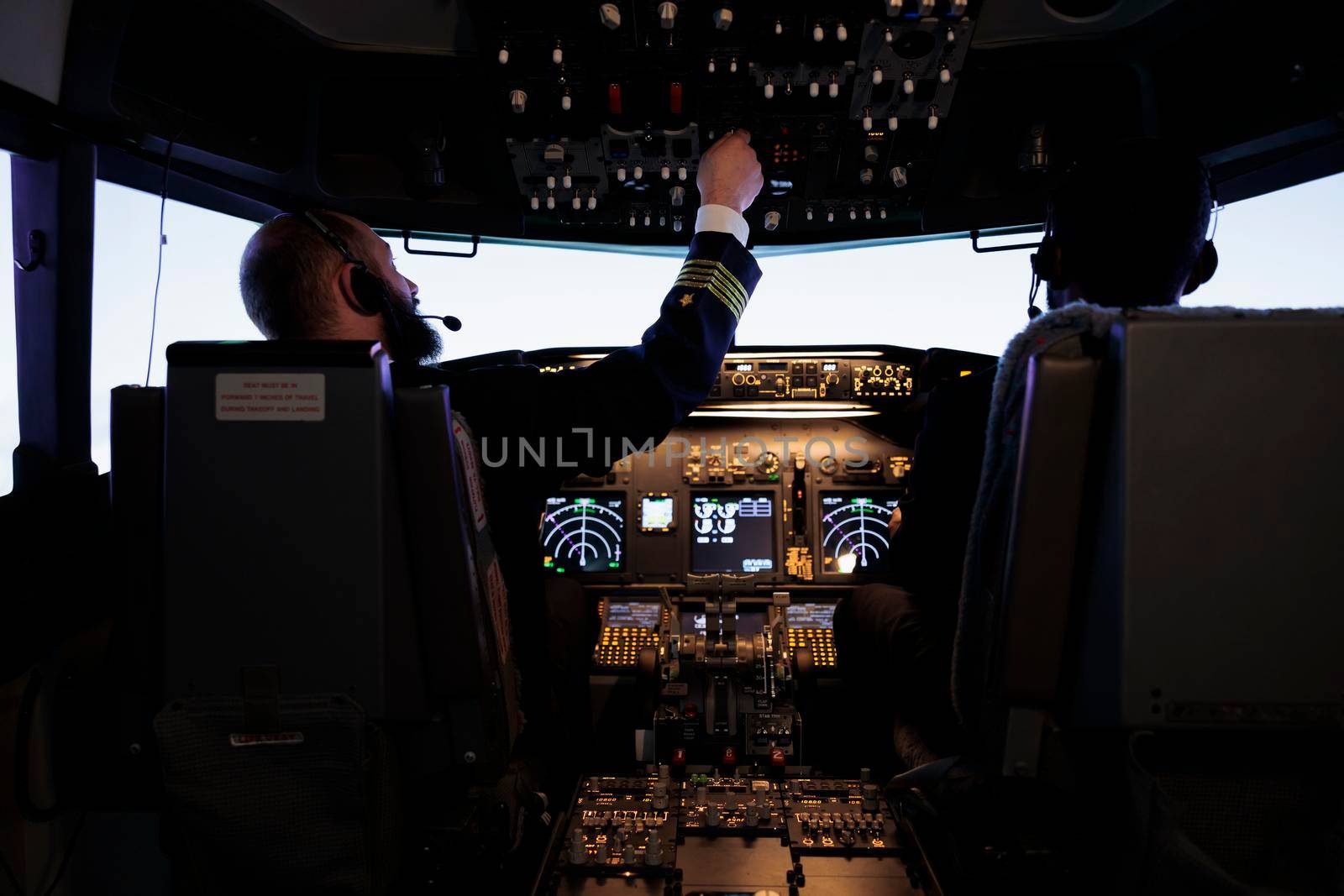 Aircraft captain pushing dashboard handle in plane cockpit, flying airplane jet with pilot and control panel command. Aircrew using engine power with switch and radar navigation on windscreen.