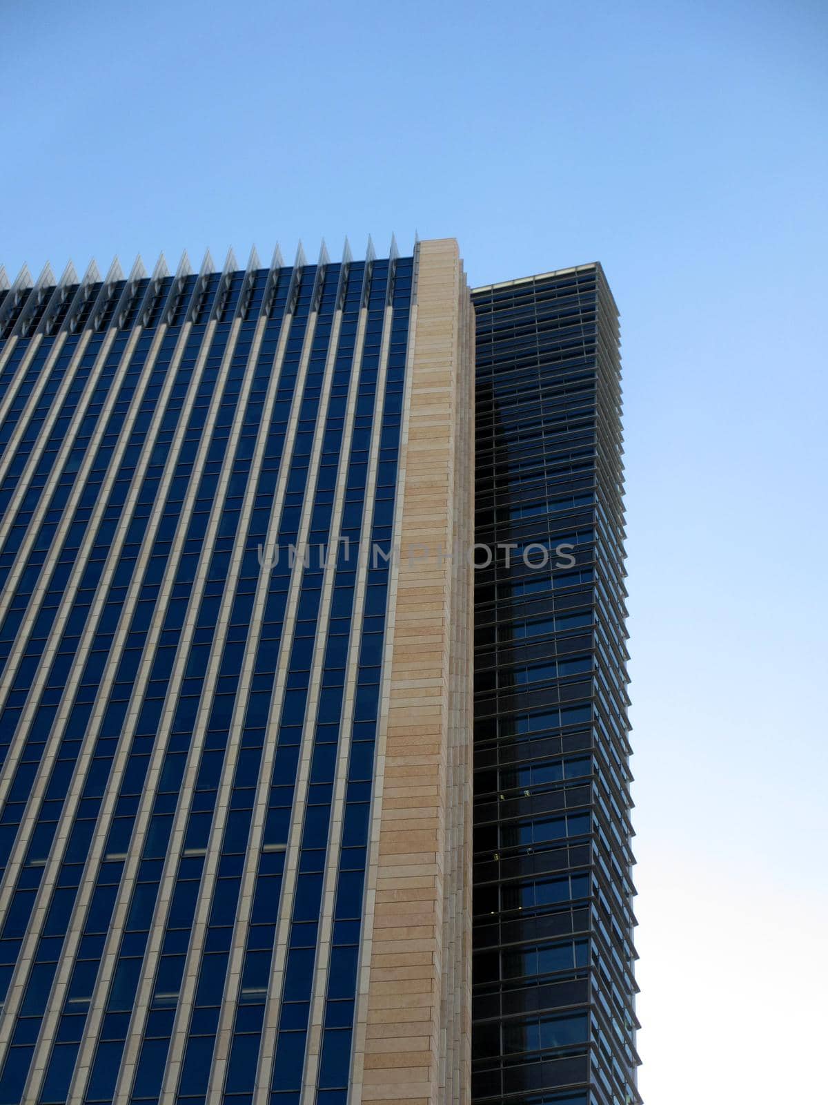 Side Angle of Modern Tall Building with a blue sky.