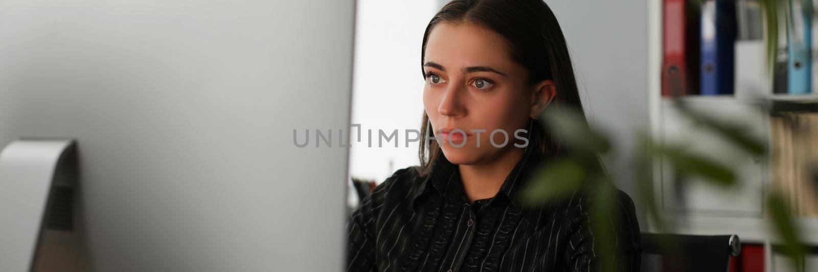 Young office worker stare at computer screen, search information online by kuprevich