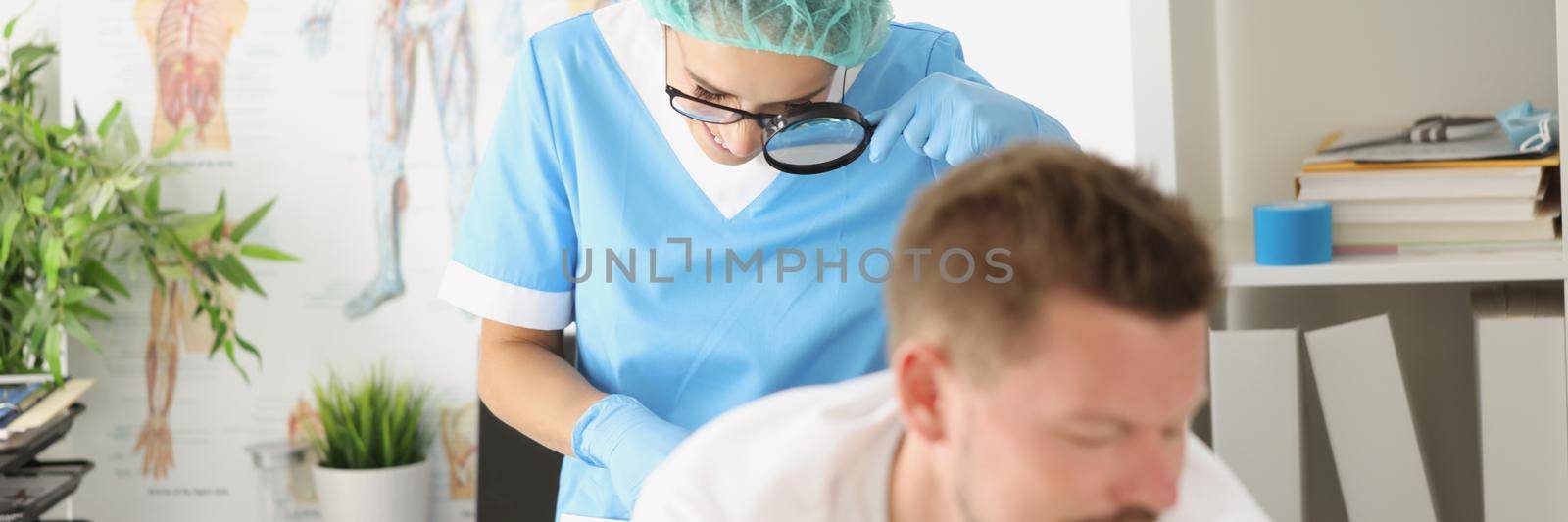 Portrait of dermatologist doctor examines mole on patients body with magnifying glass. Man worried about birthmark. Diagnostic, medicine, analysis concept