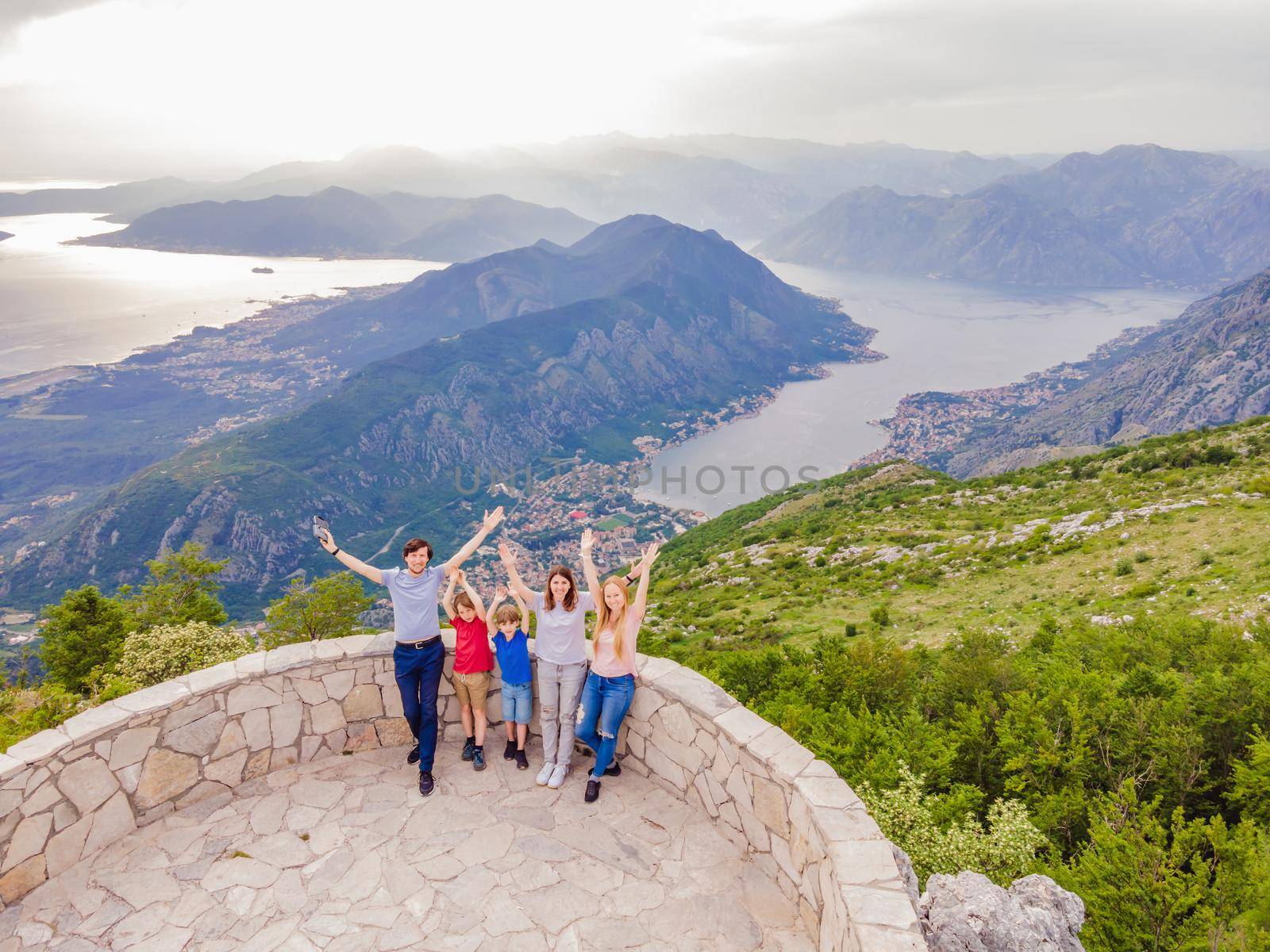 happy friends enjoys the view of Kotor. Montenegro. Bay of Kotor, Gulf of Kotor, Boka Kotorska and walled old city. Travel to Montenegro concept. Fortifications of Kotor is on UNESCO World Heritage by galitskaya
