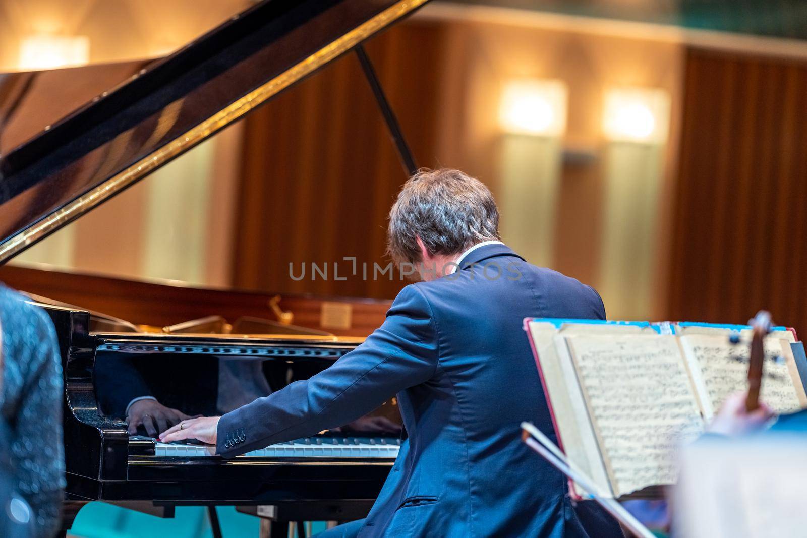 a piano on the Philharmonic stage among other musical instruments.