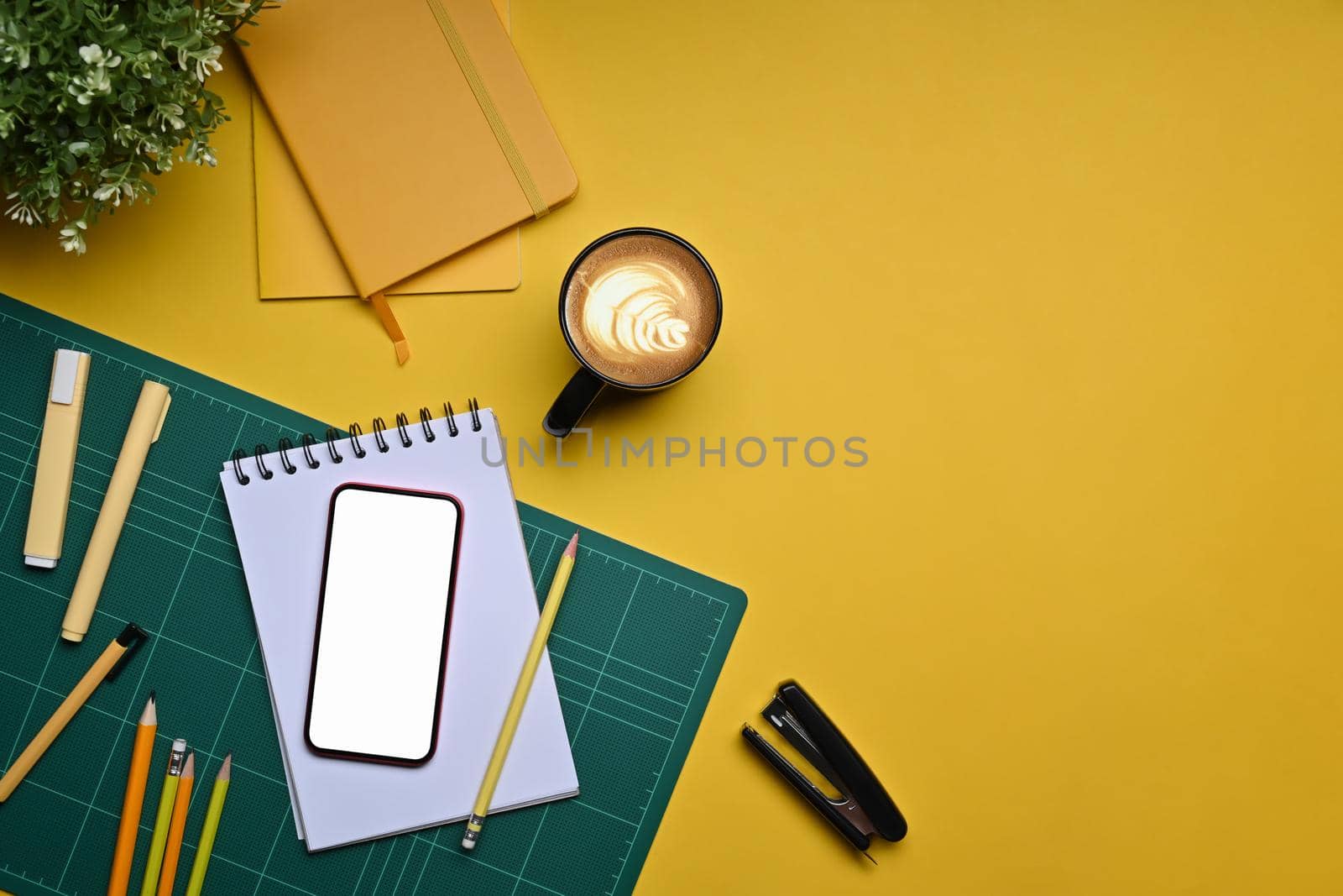 Mock up smart phone, coffee cup and stationery on yellow background. by prathanchorruangsak
