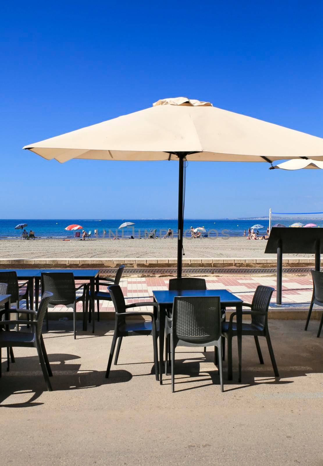 Santa Pola, Alicante, Spain- June 30, 2022: Beach bar Restaurant with empty terrace on Levante beach on a sunny day