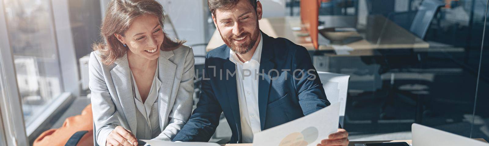 Positive business people on laptop during a meeting discussing financial charts by Yaroslav_astakhov