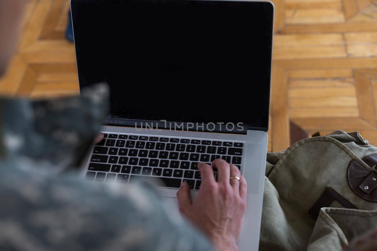 soldier in military uniform using high tech computer in headquarters intelligence center by Andelov13