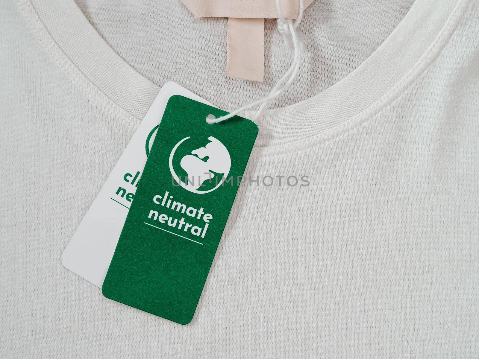 Carbon neutral t-shirt, Label Climate neutral on new clothes. Carbon neutral label concept in apparel, fashion industry. Ethical consumption.Increasing awareness for customers - carbon footpint