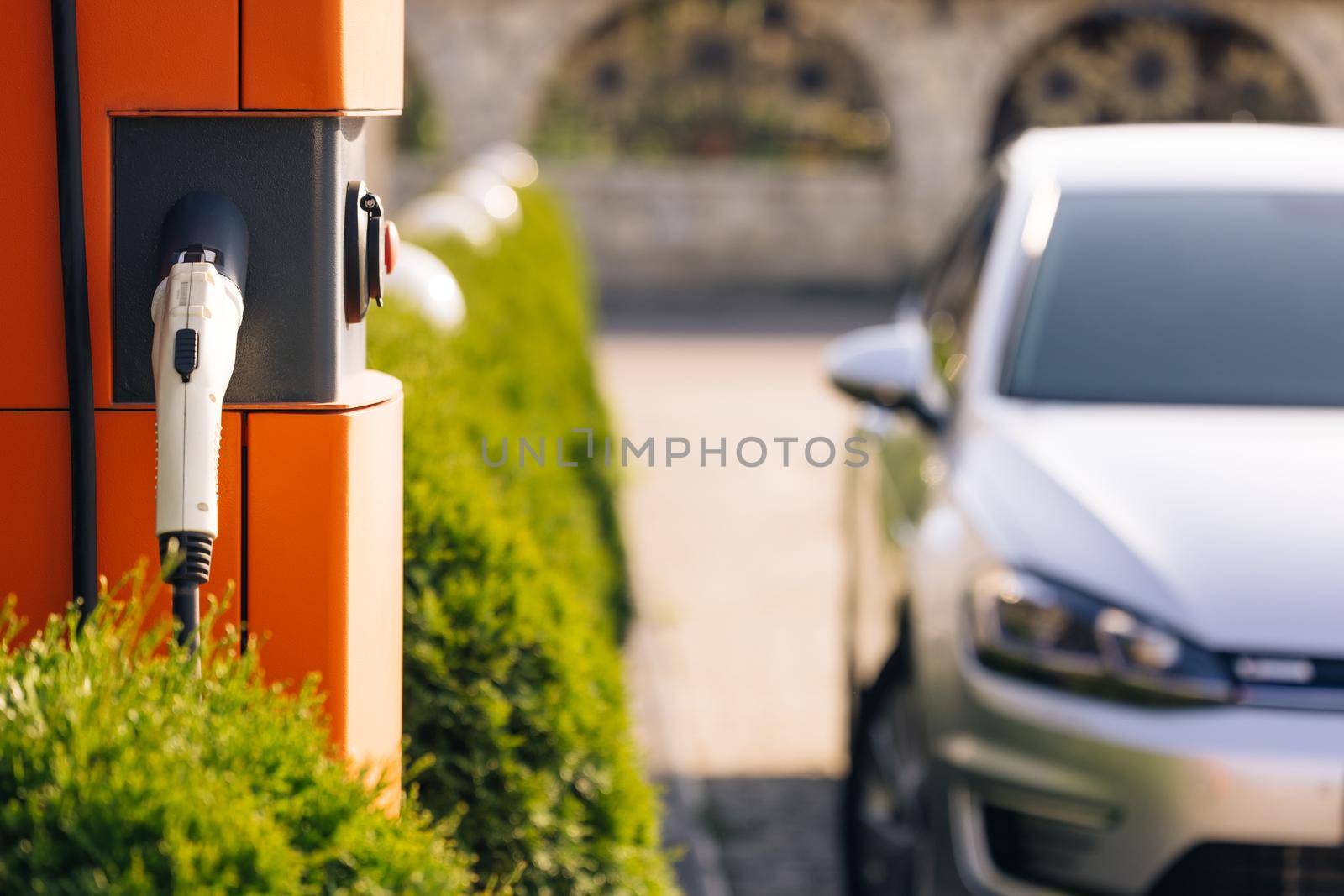 Electric charging station for charging cars. Charge station for electric cars. Electric car charger on street by uflypro