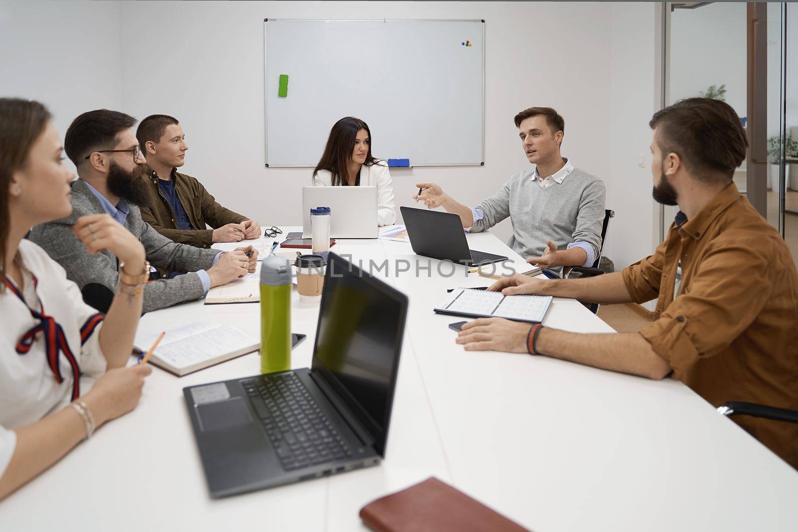 Making great decisions. Team and manager discussing during the meeting in IT office by berezko