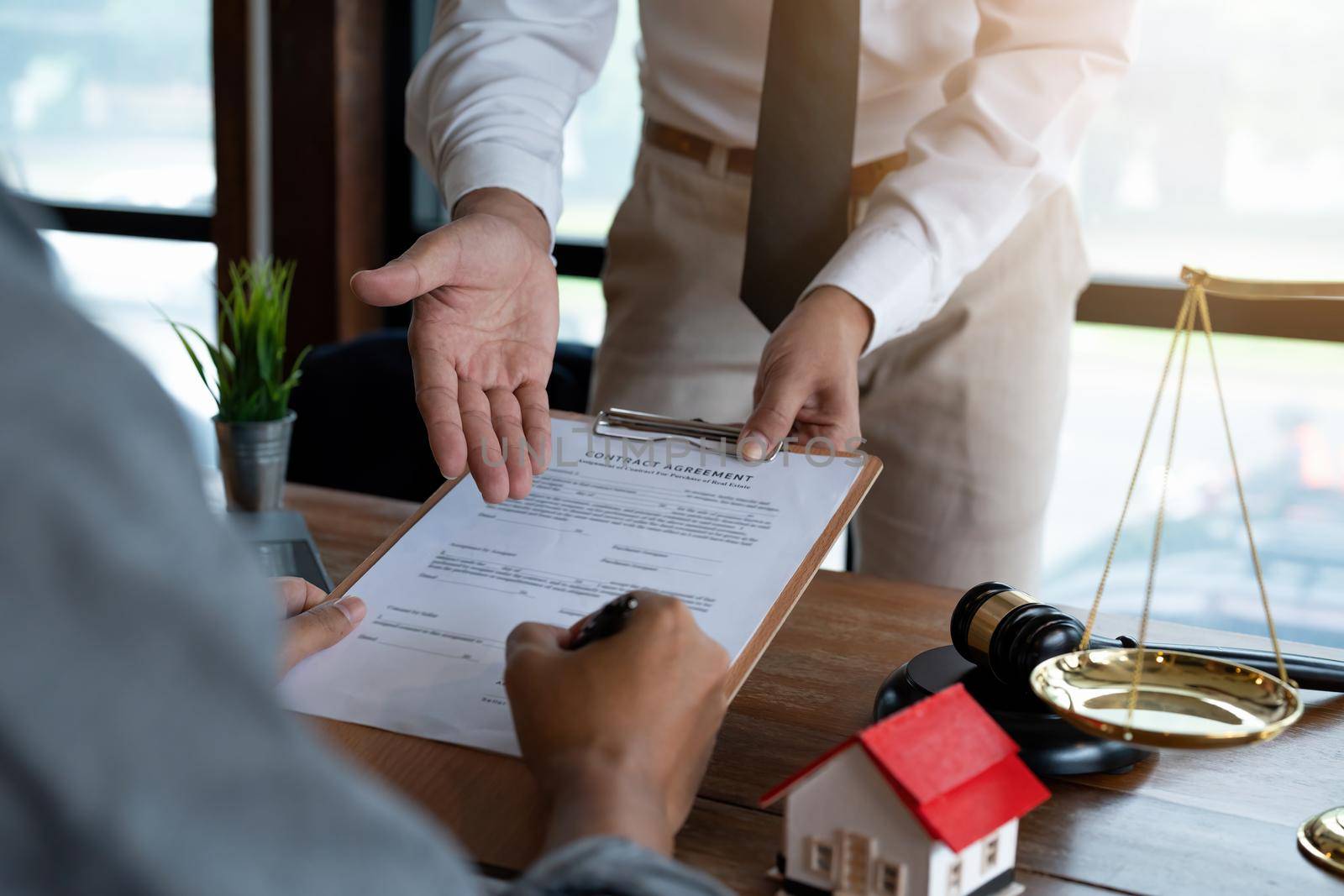 Real estate company to buy houses and land are delivering keys and houses to customers after agreeing to make a home purchase agreement and make a loan agreement. Discussion with a real estate agent