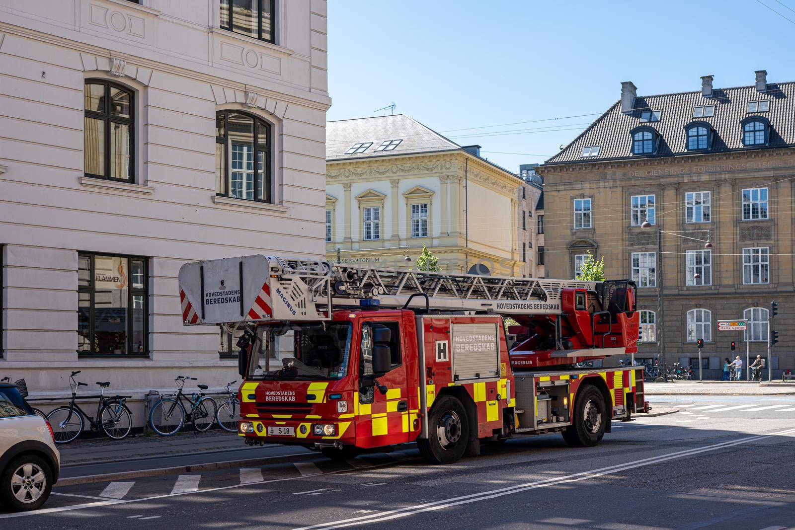 Copenhagen, Denmark - July 12, 2022: Side view of a fire truck parked in a street.