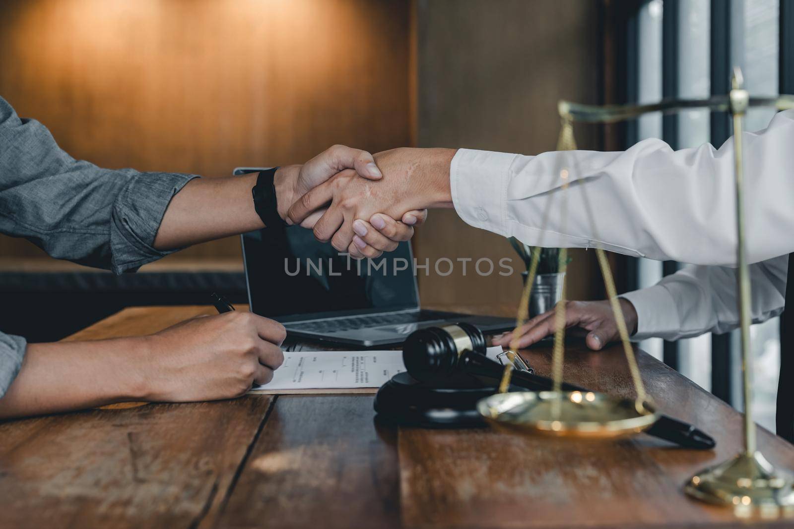 Business people shaking hands, finishing up a papers signing. Meeting, contract and lawyer consulting concept