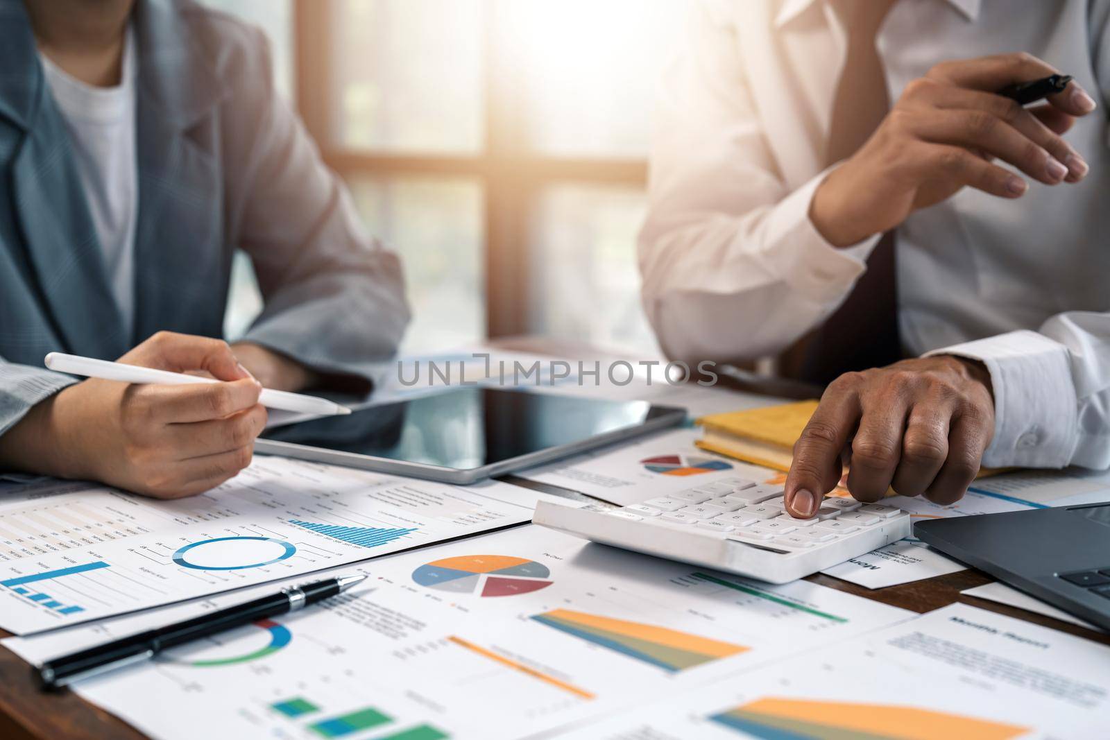 Asian business adviser meeting to analyze and discuss the situation on the financial report in the meeting room.Investment Consultant, Financial advisor and accounting concept.